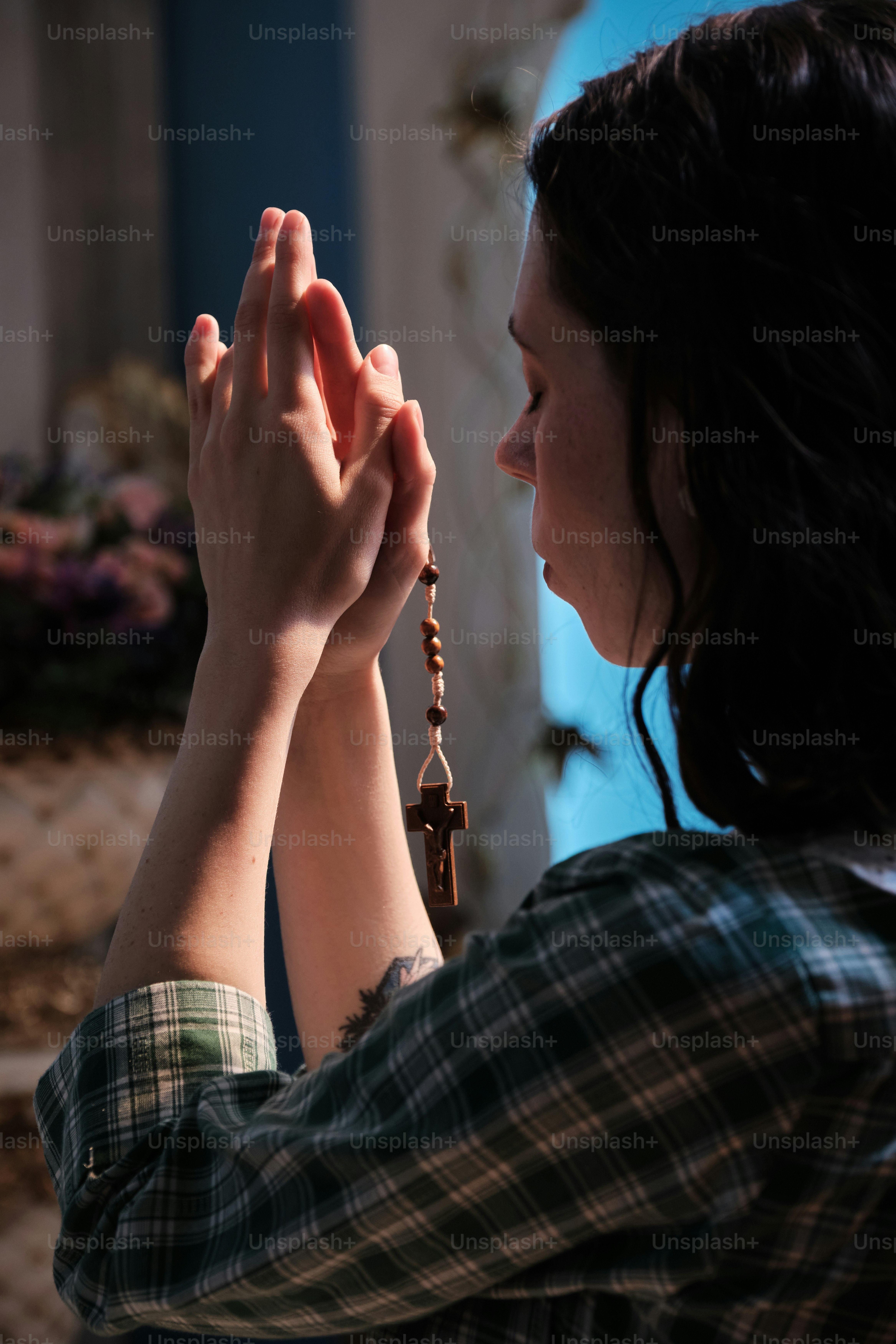 a woman holding a rosary in her hands