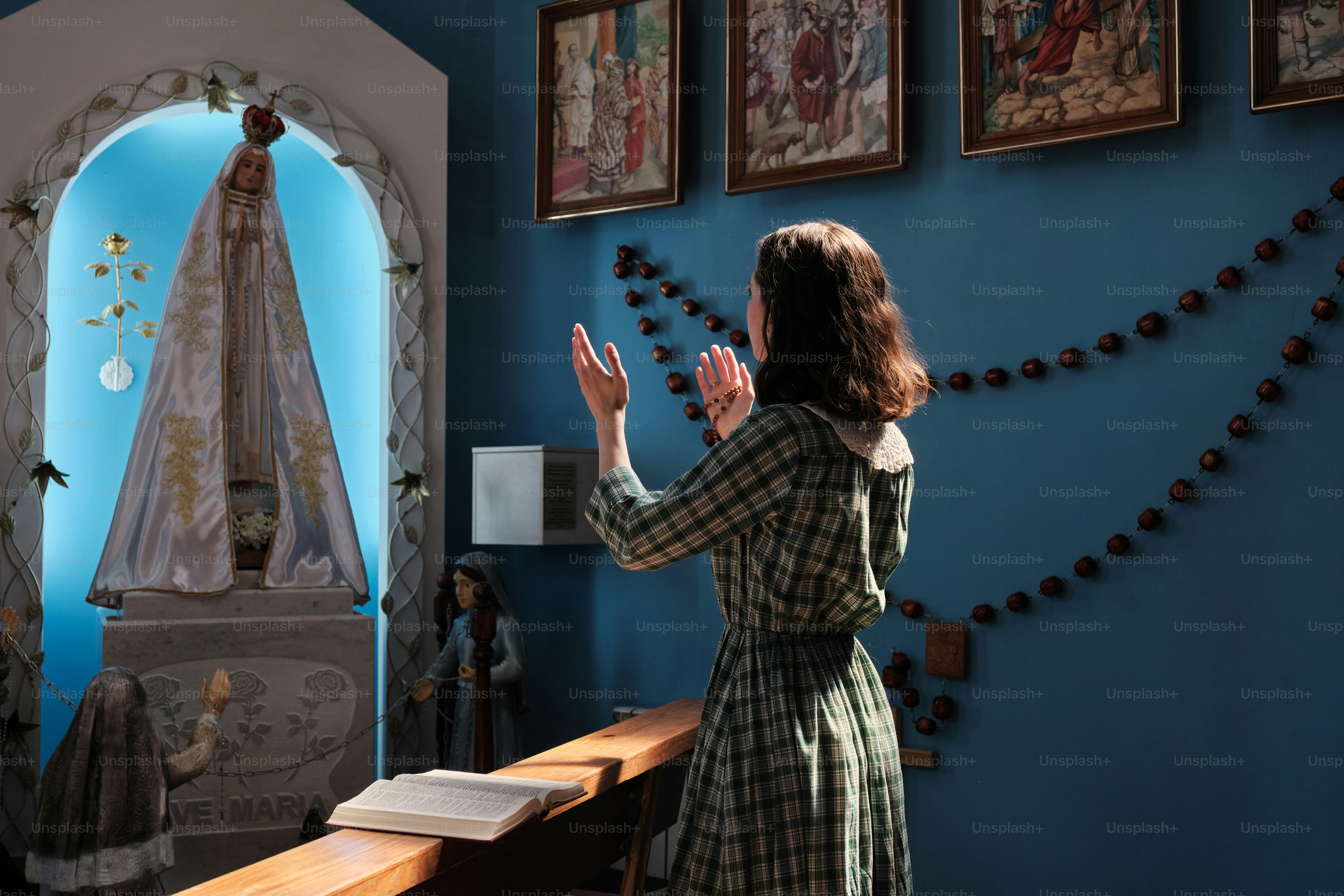 a woman standing in front of a blue wall