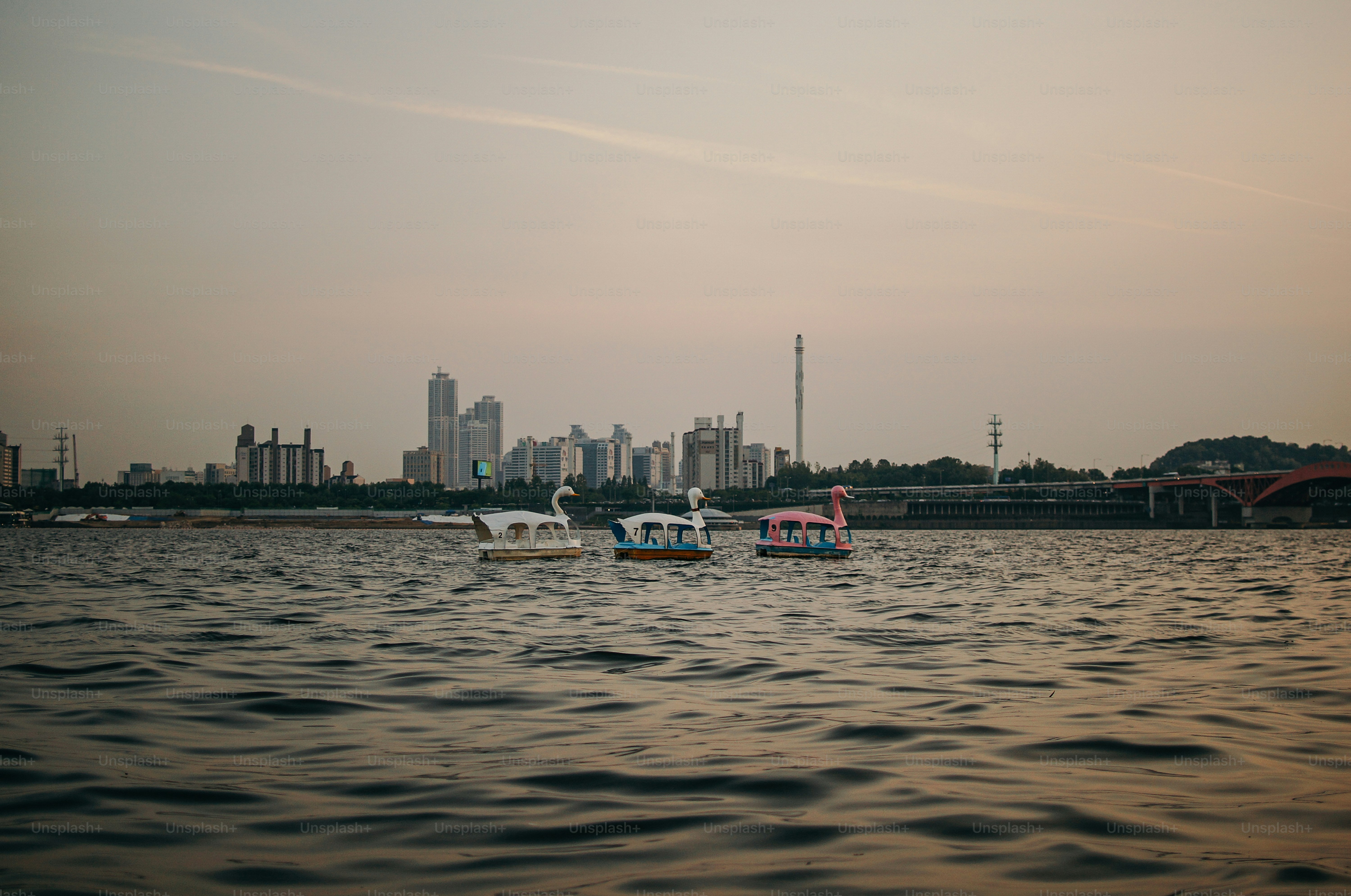 a couple of boats floating on top of a lake