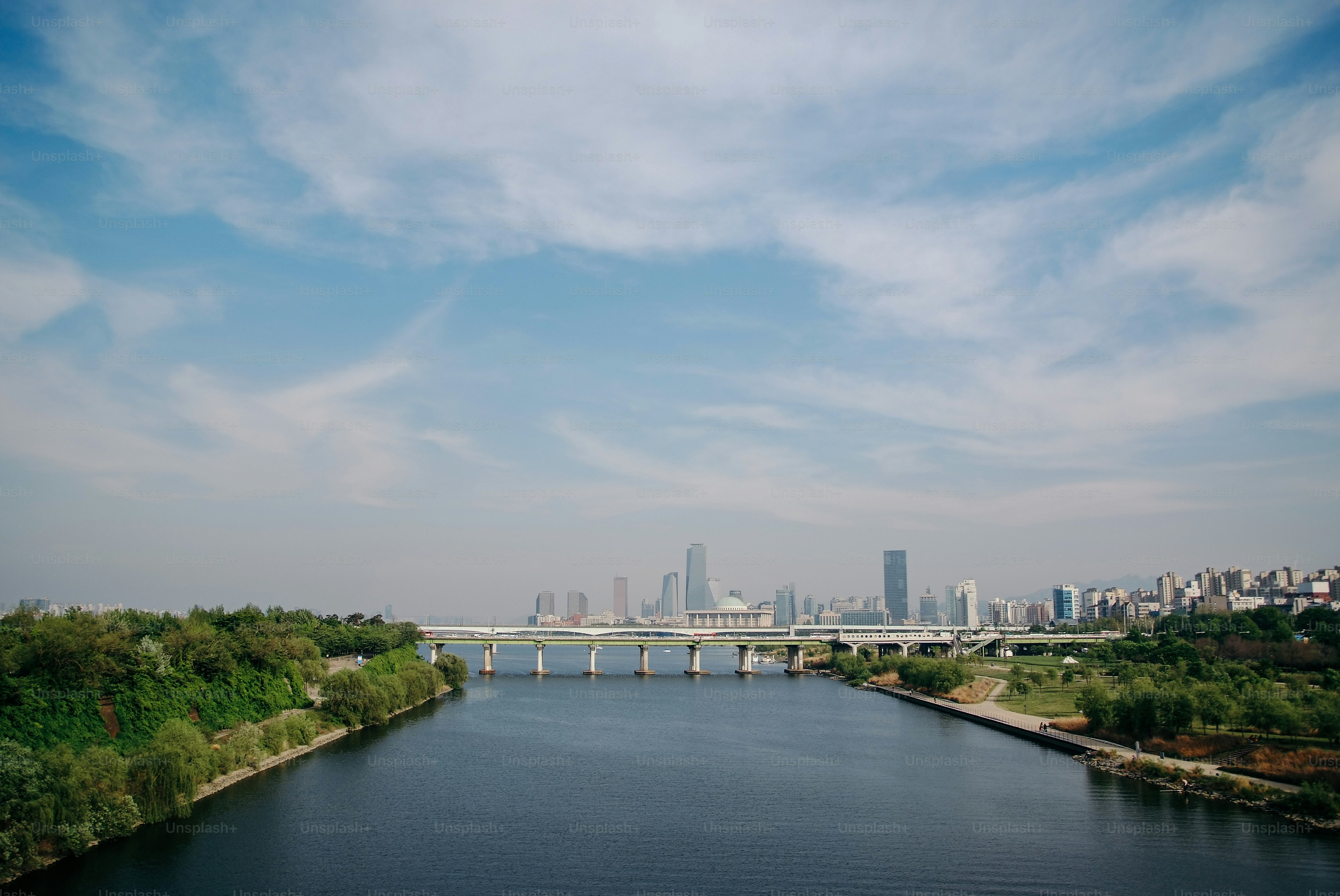 a large body of water with a bridge in the background