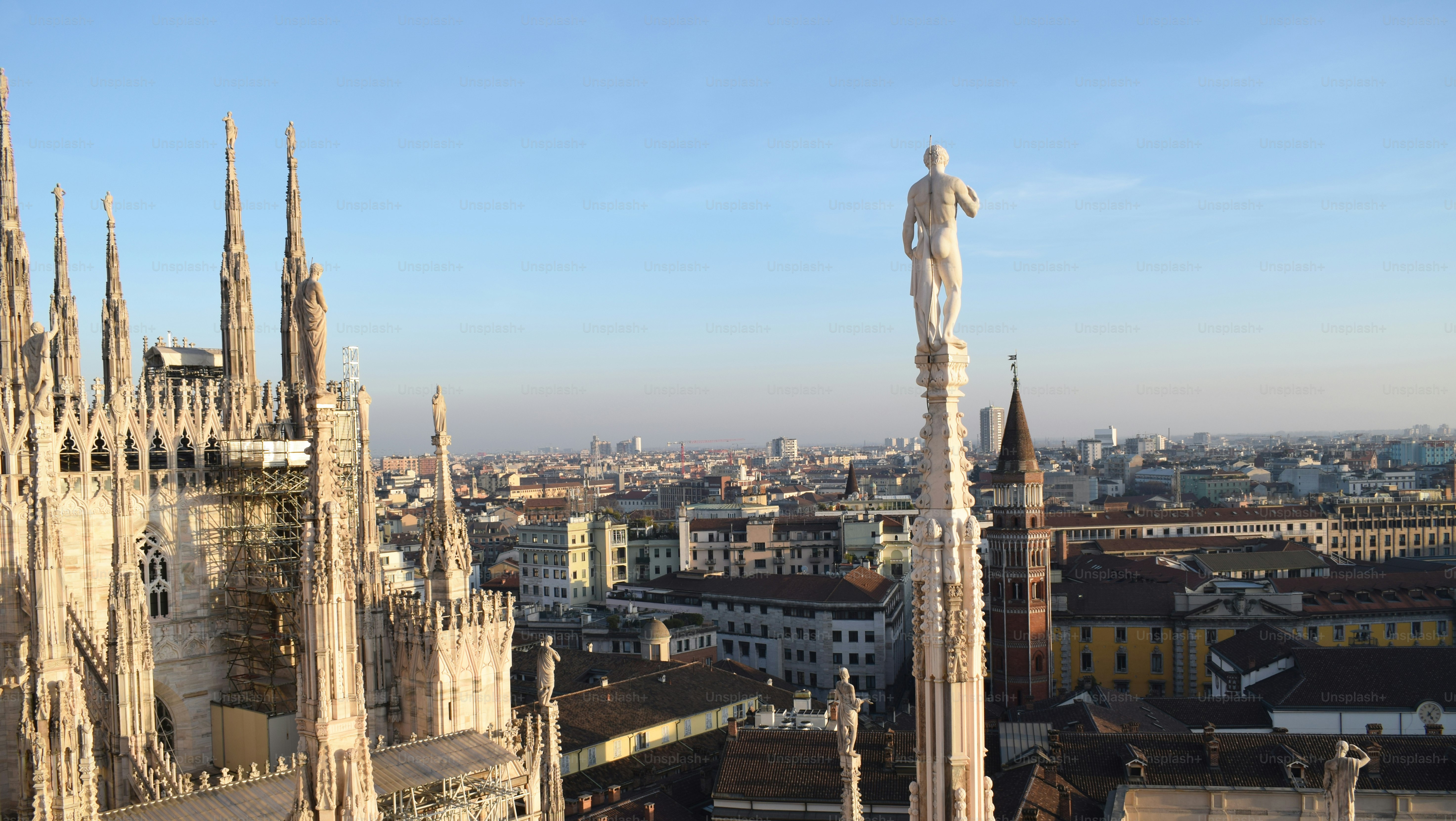 a view of a city with a statue on top of it