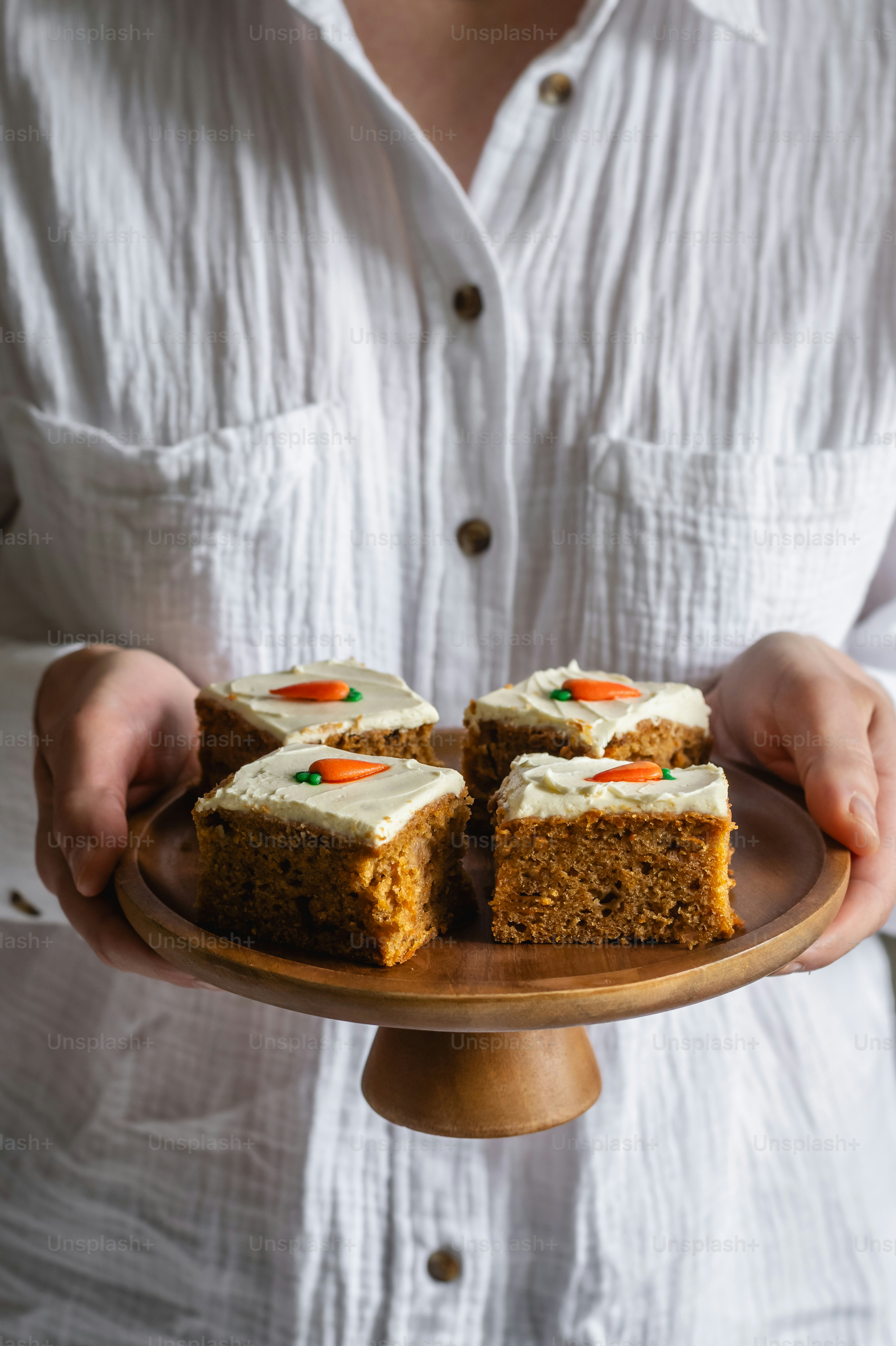 a person holding a plate with a cake on it