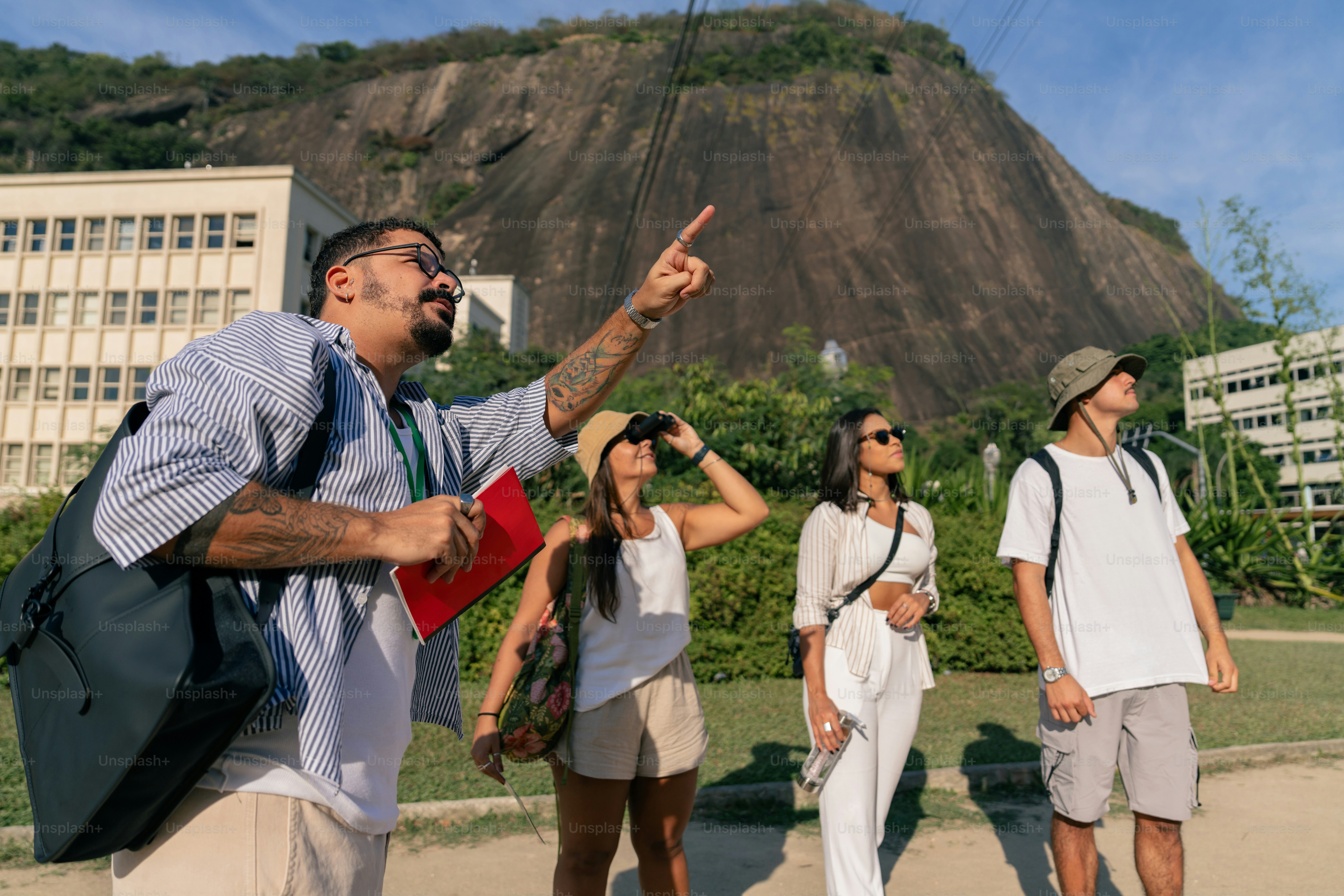 a group of people standing around a man flying a kite