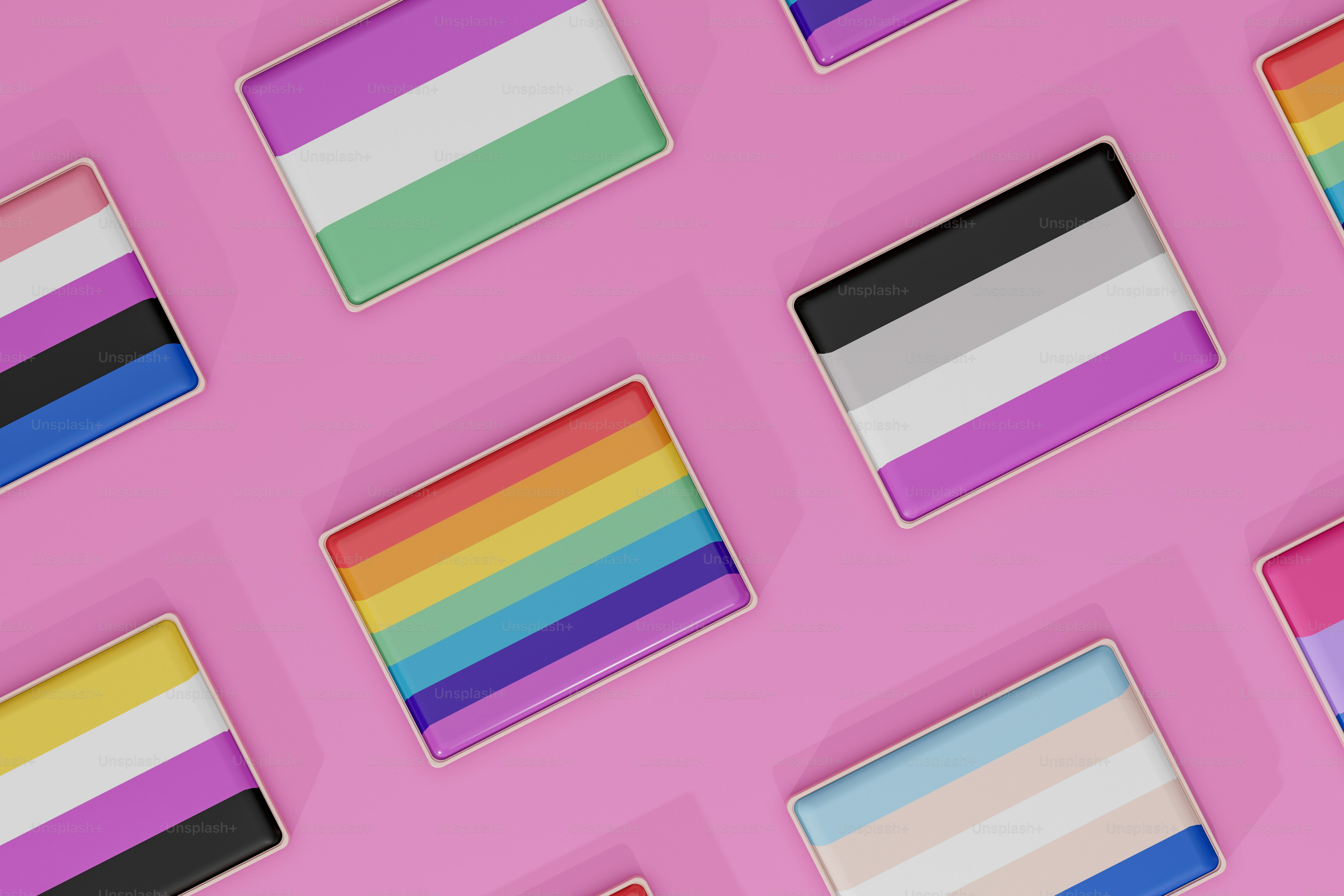 a bunch of different colored stickers on a pink surface