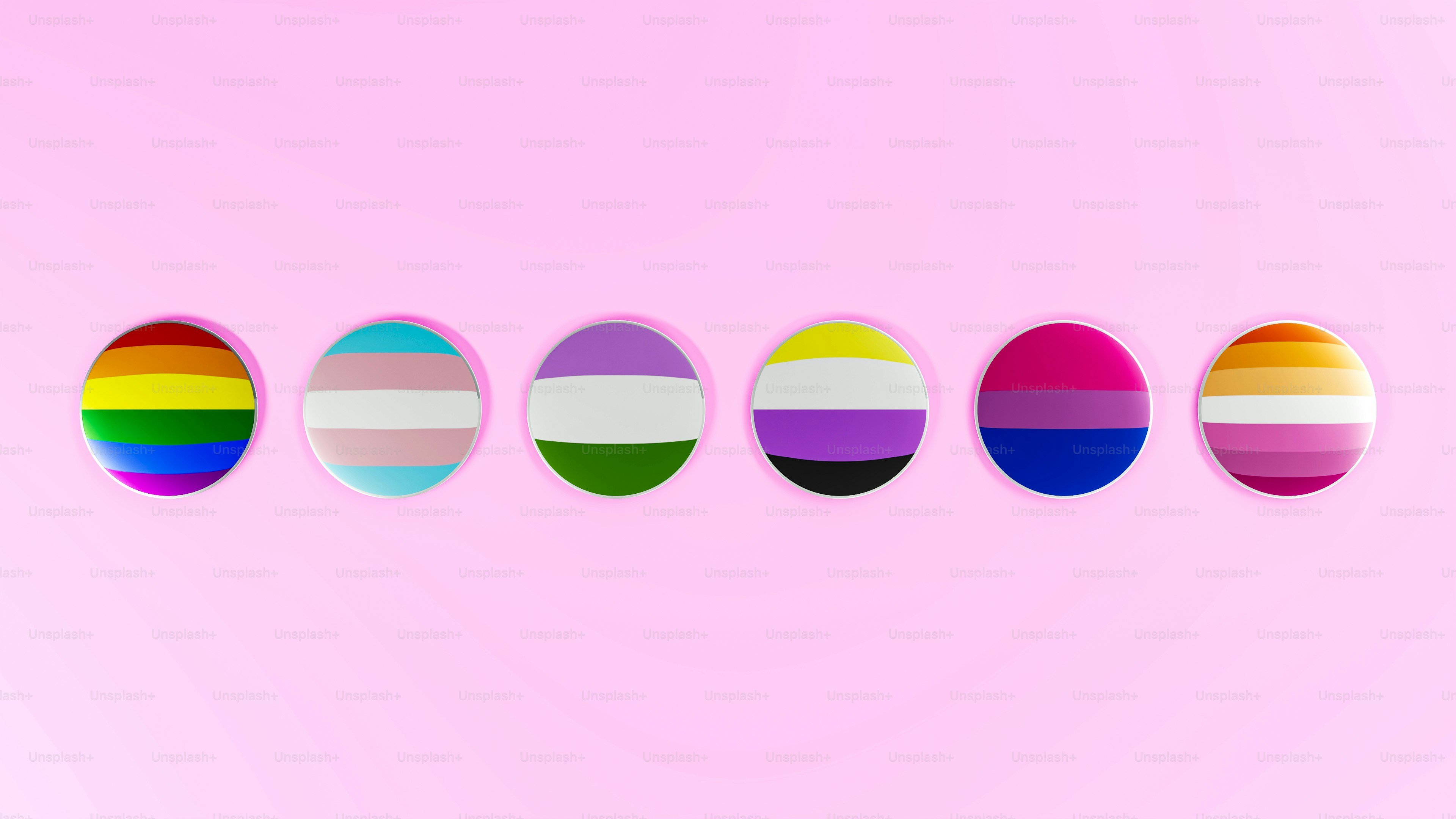 a row of different colored eggs on a pink background
