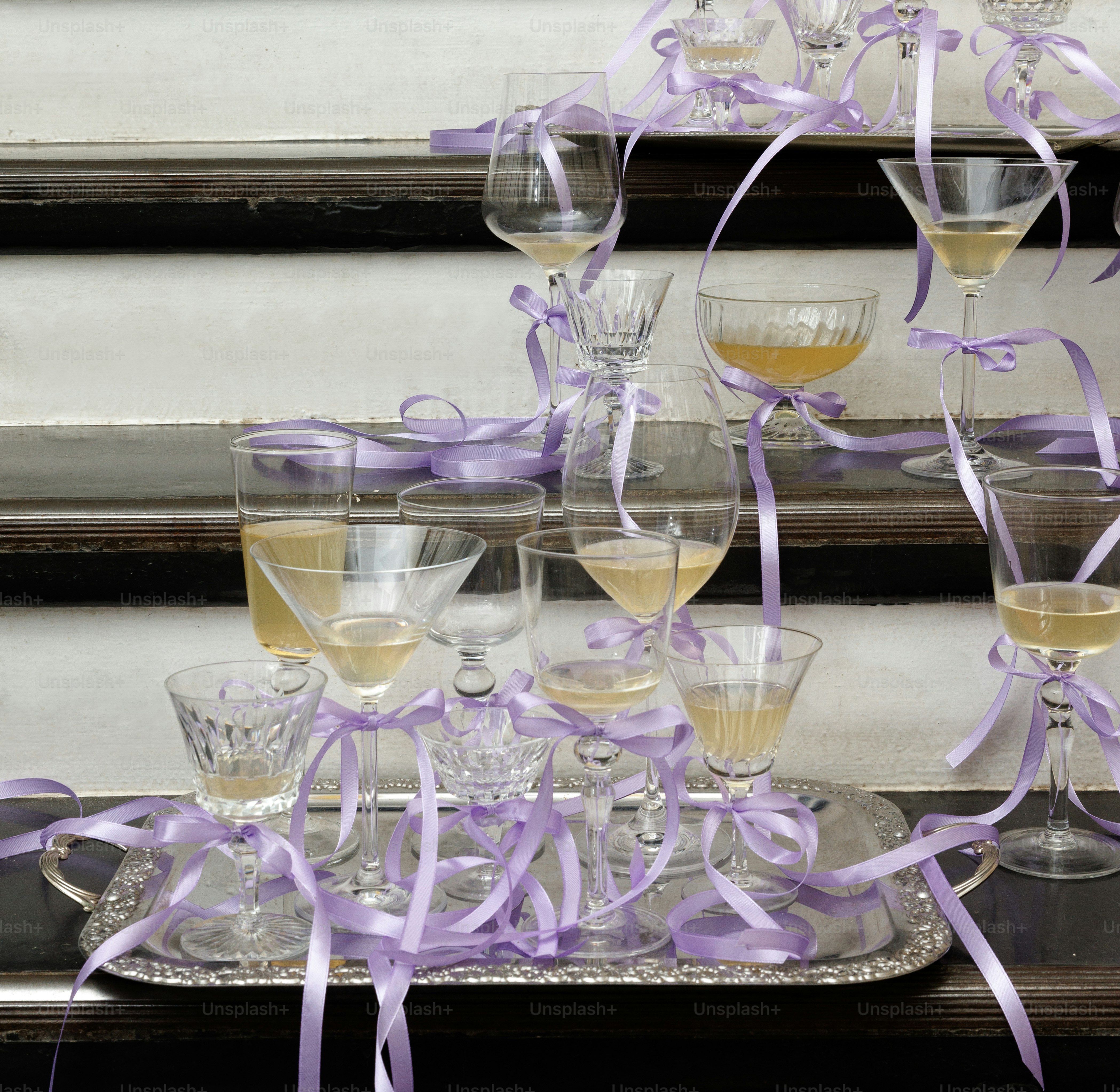 a tray filled with glasses of wine on top of a table