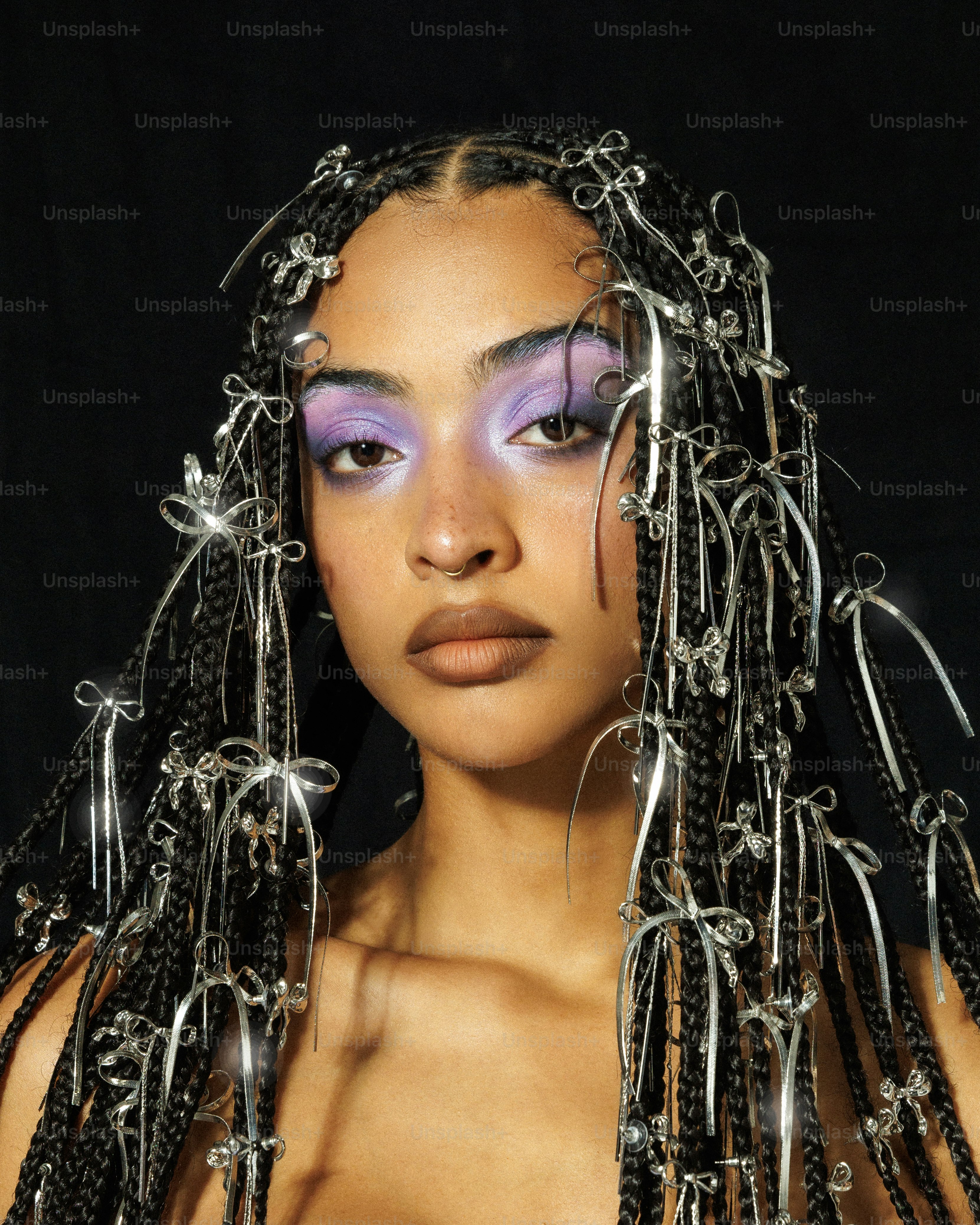 a woman with purple makeup and chains on her head