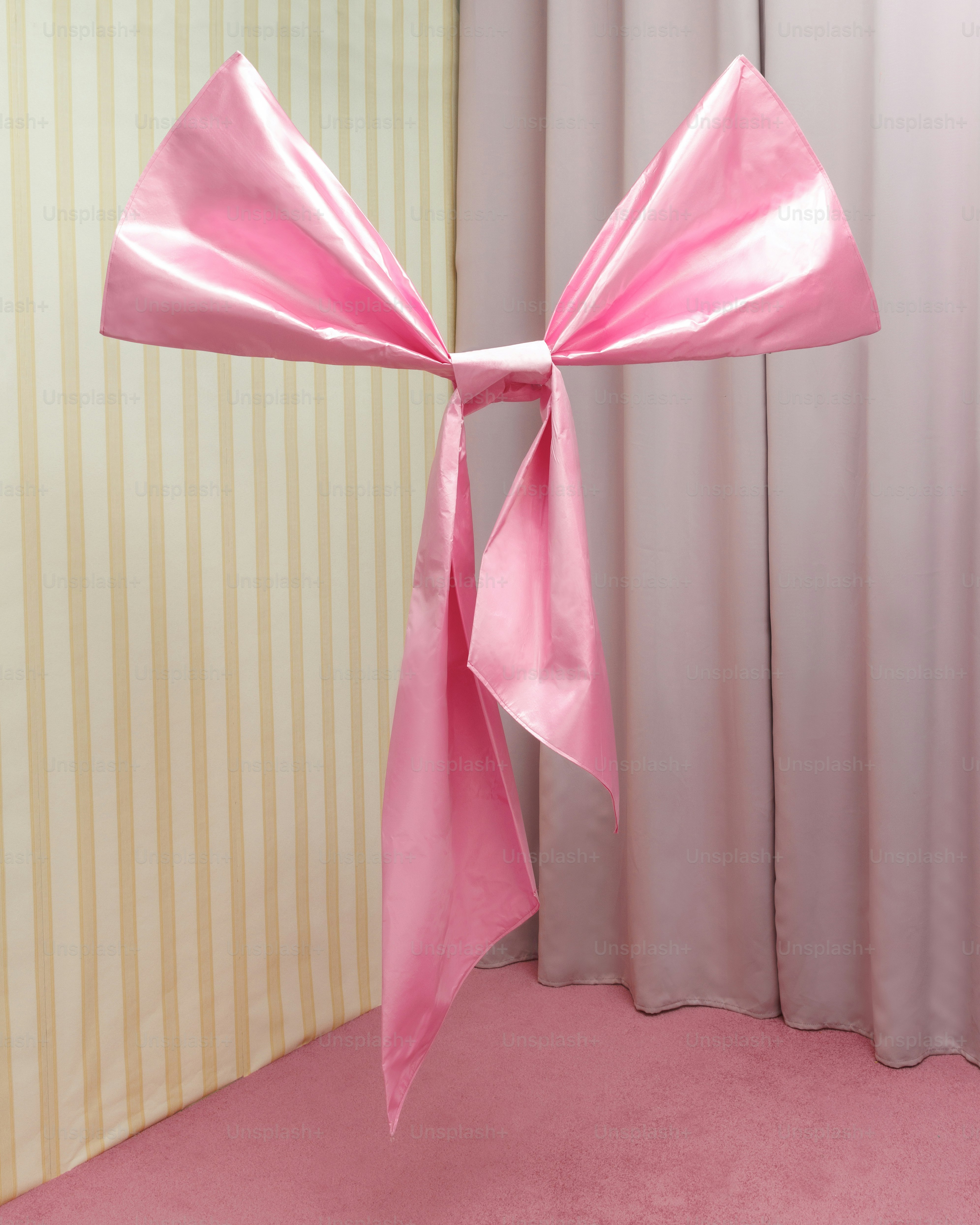 a pink chair with a pink bow on it