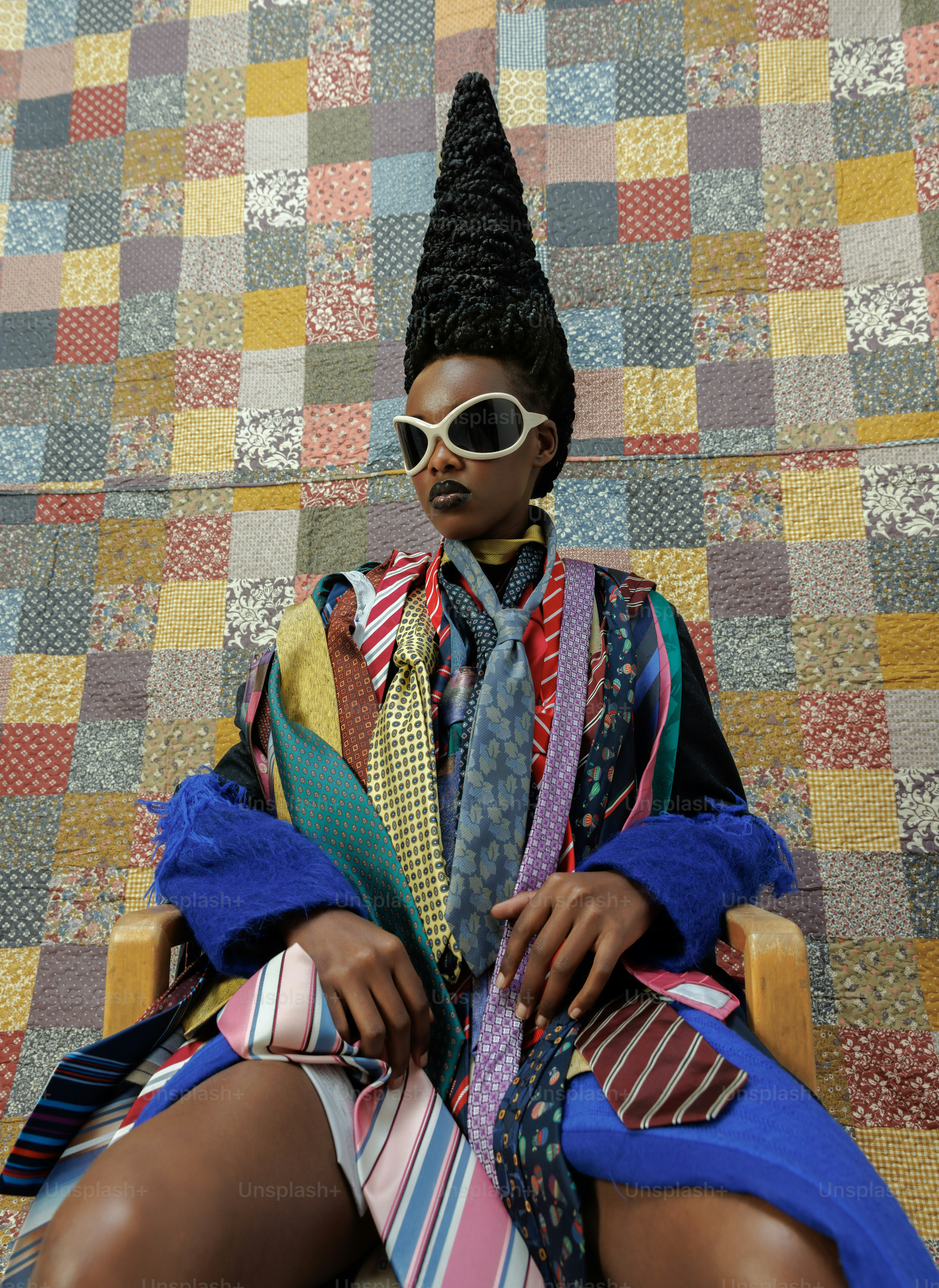 a woman sitting on top of a chair wearing a tie