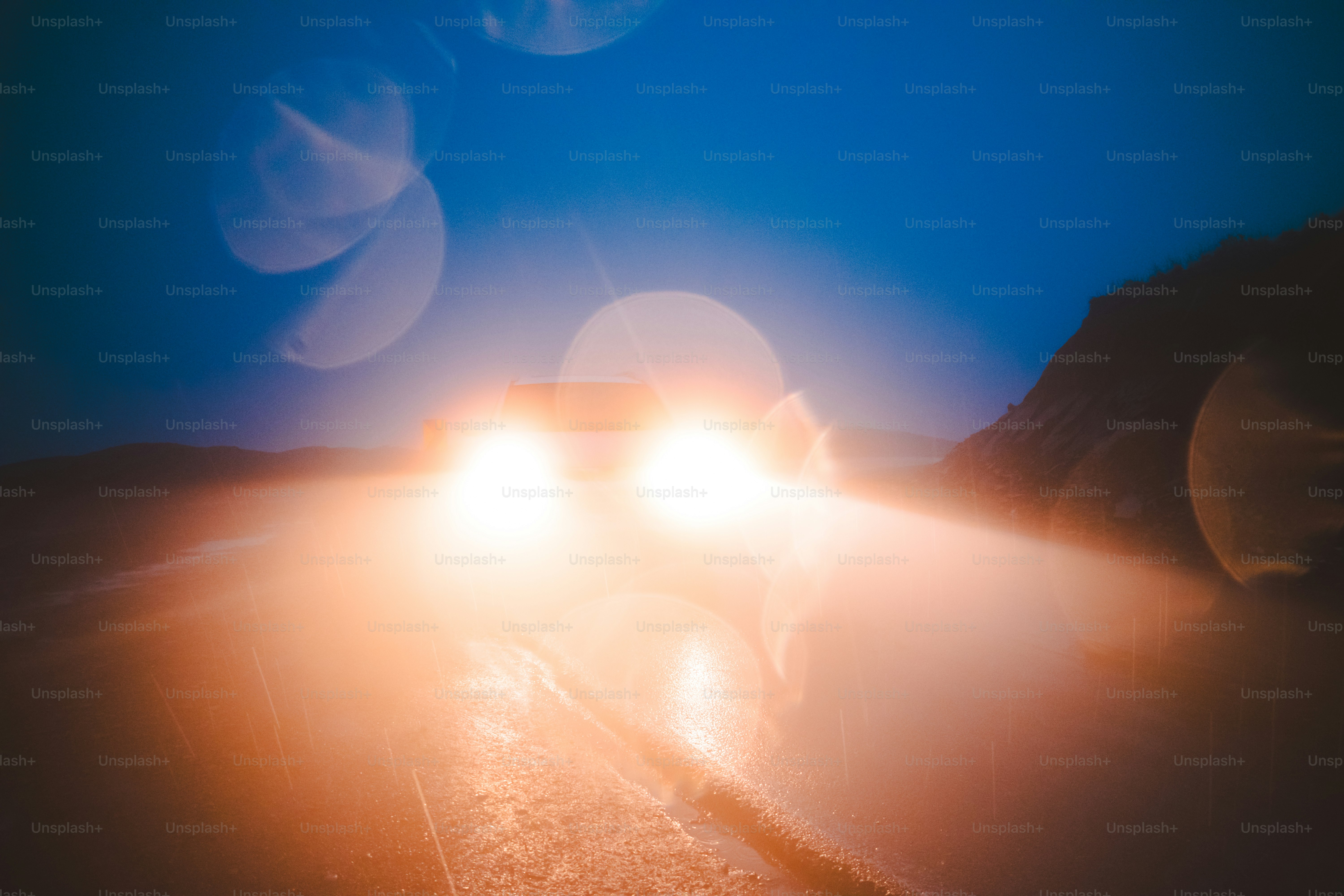 a car driving down a road at night