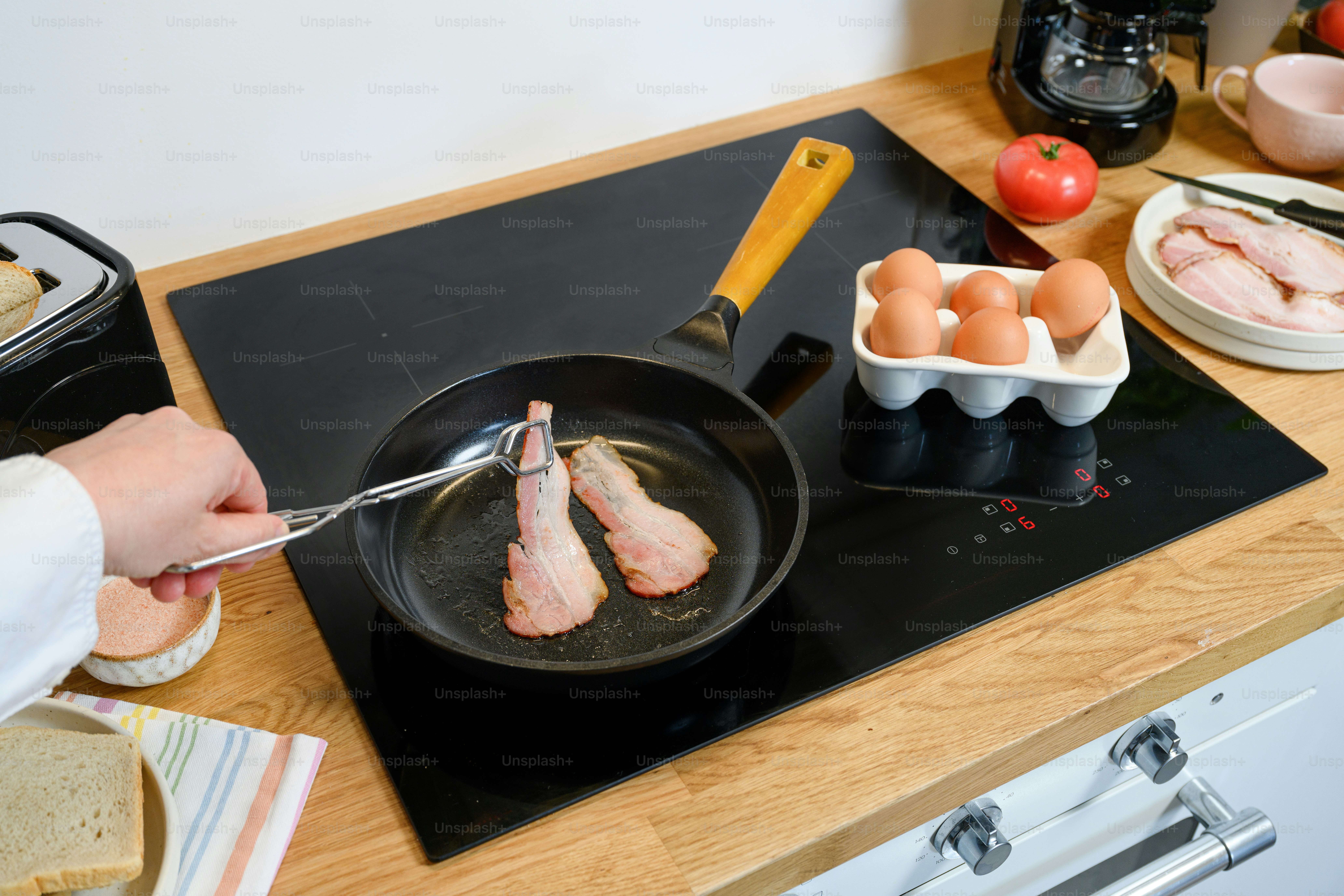 a person is frying eggs in a frying pan