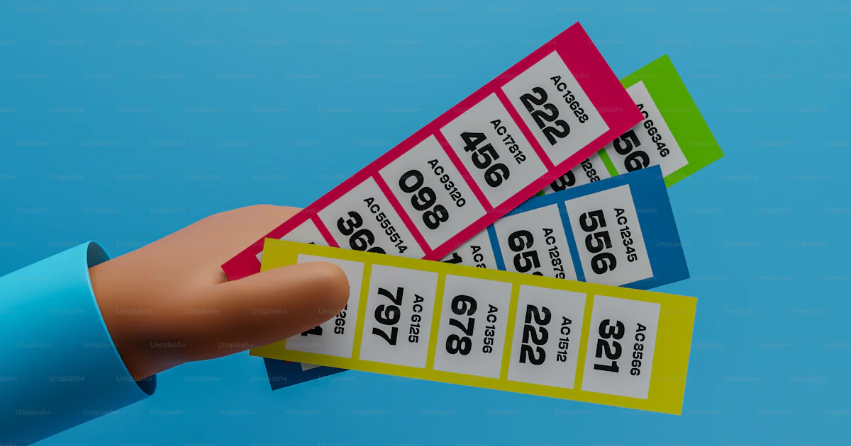 Handing Out Raffle Tickets A hand holding a pair of tickets against a blue background photo ...