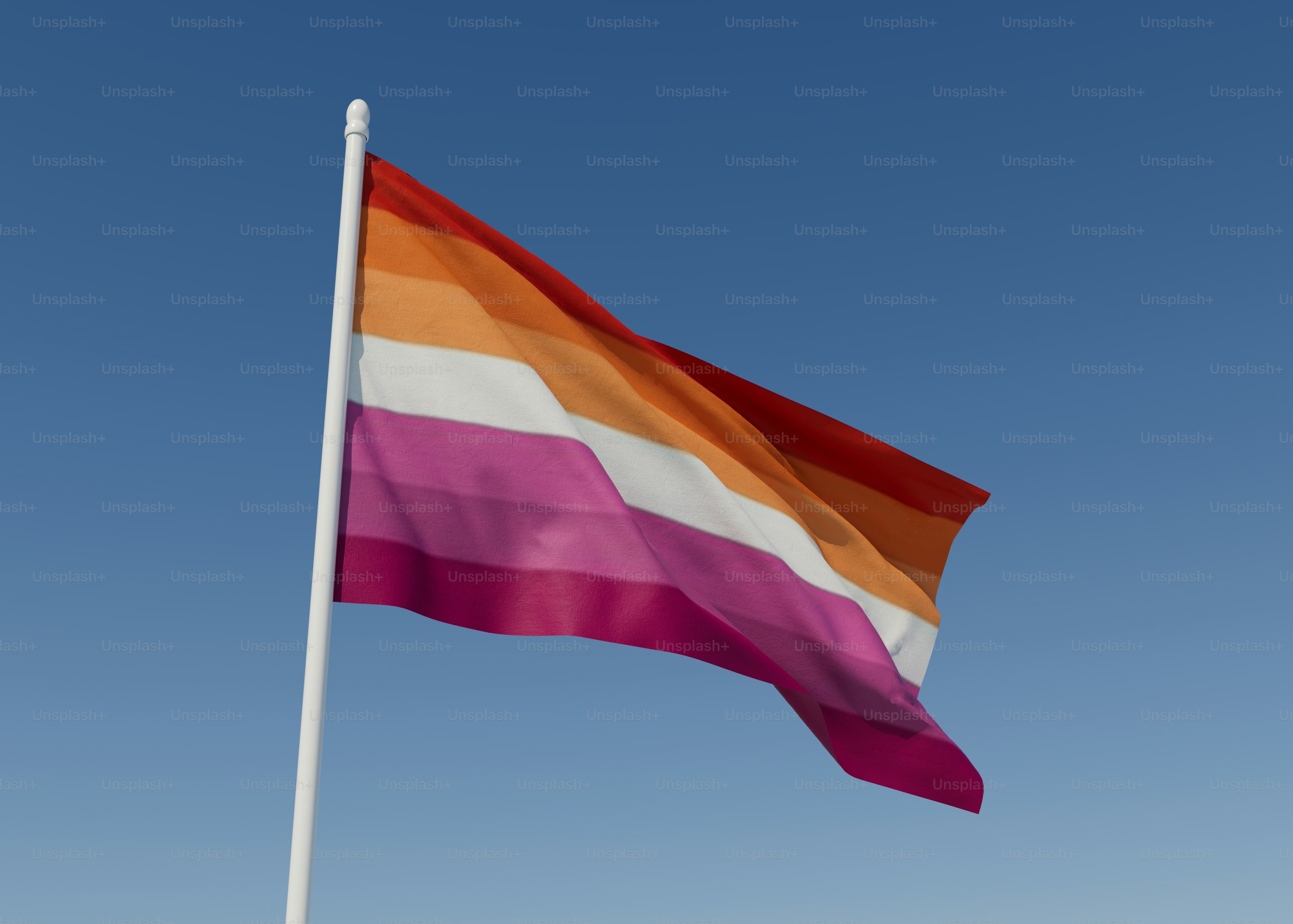 a multicolored flag flying in the wind