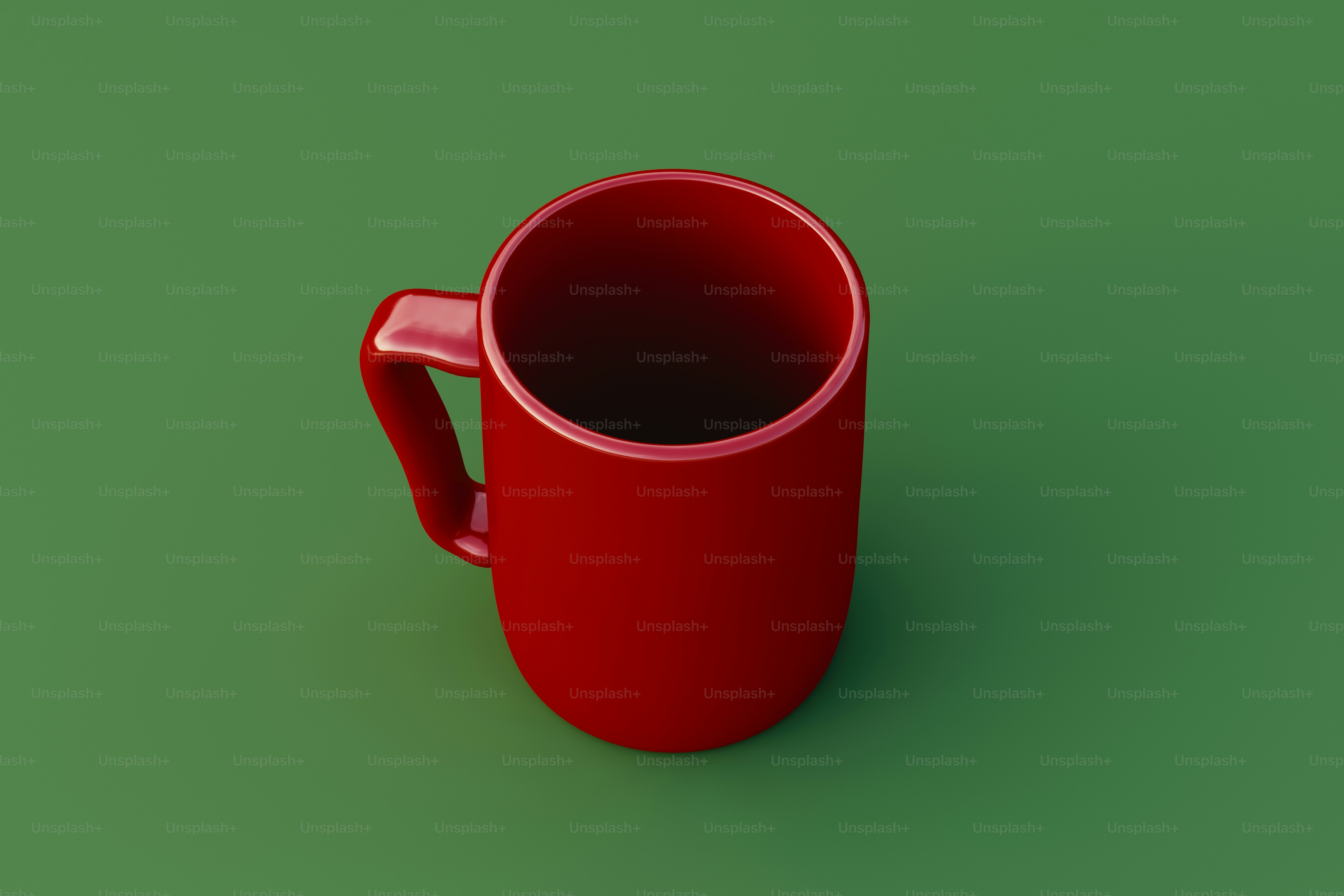 A red mug sitting on top of a green surface