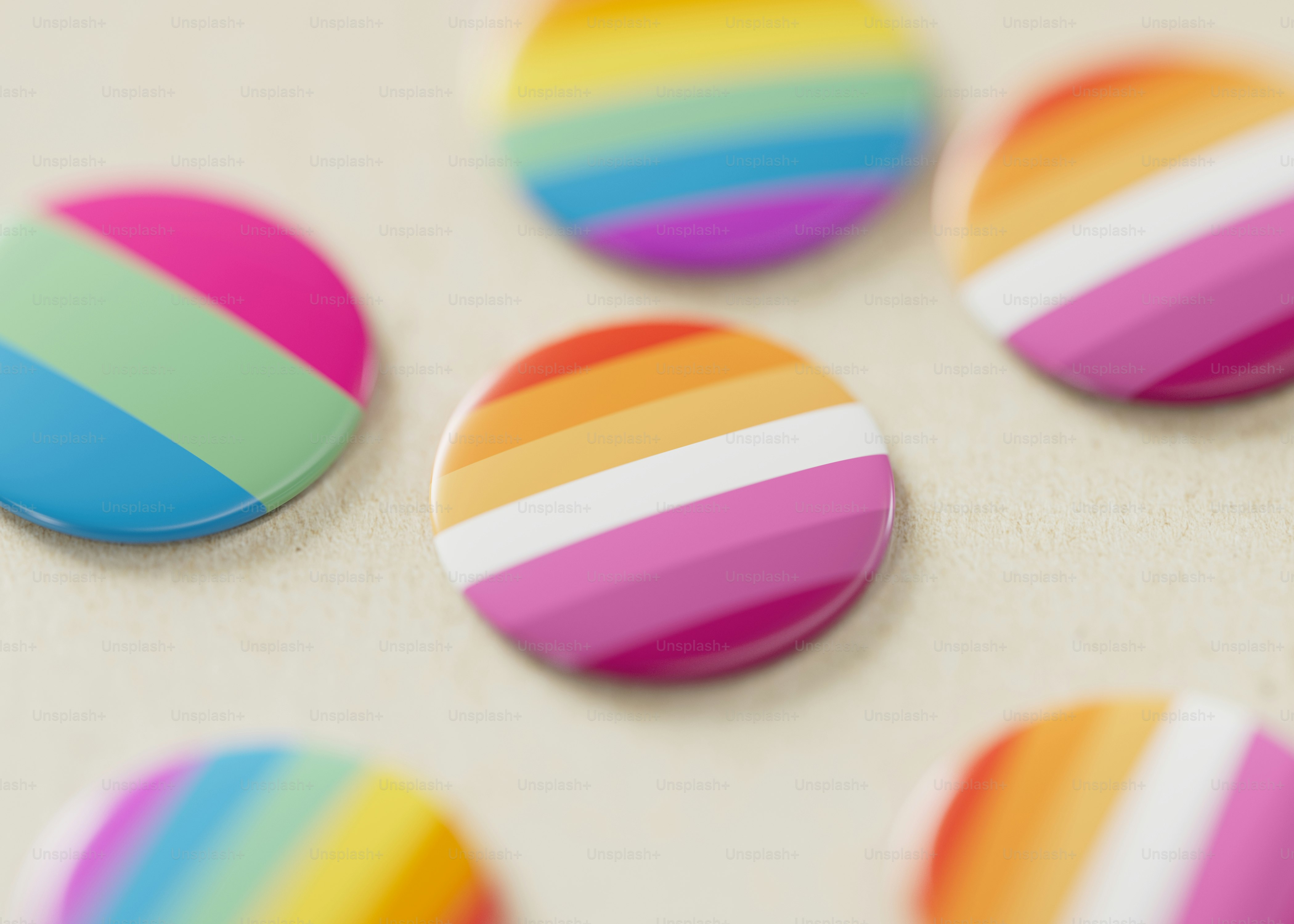 A group of multicolored buttons sitting on top of a table photo – Pride ...
