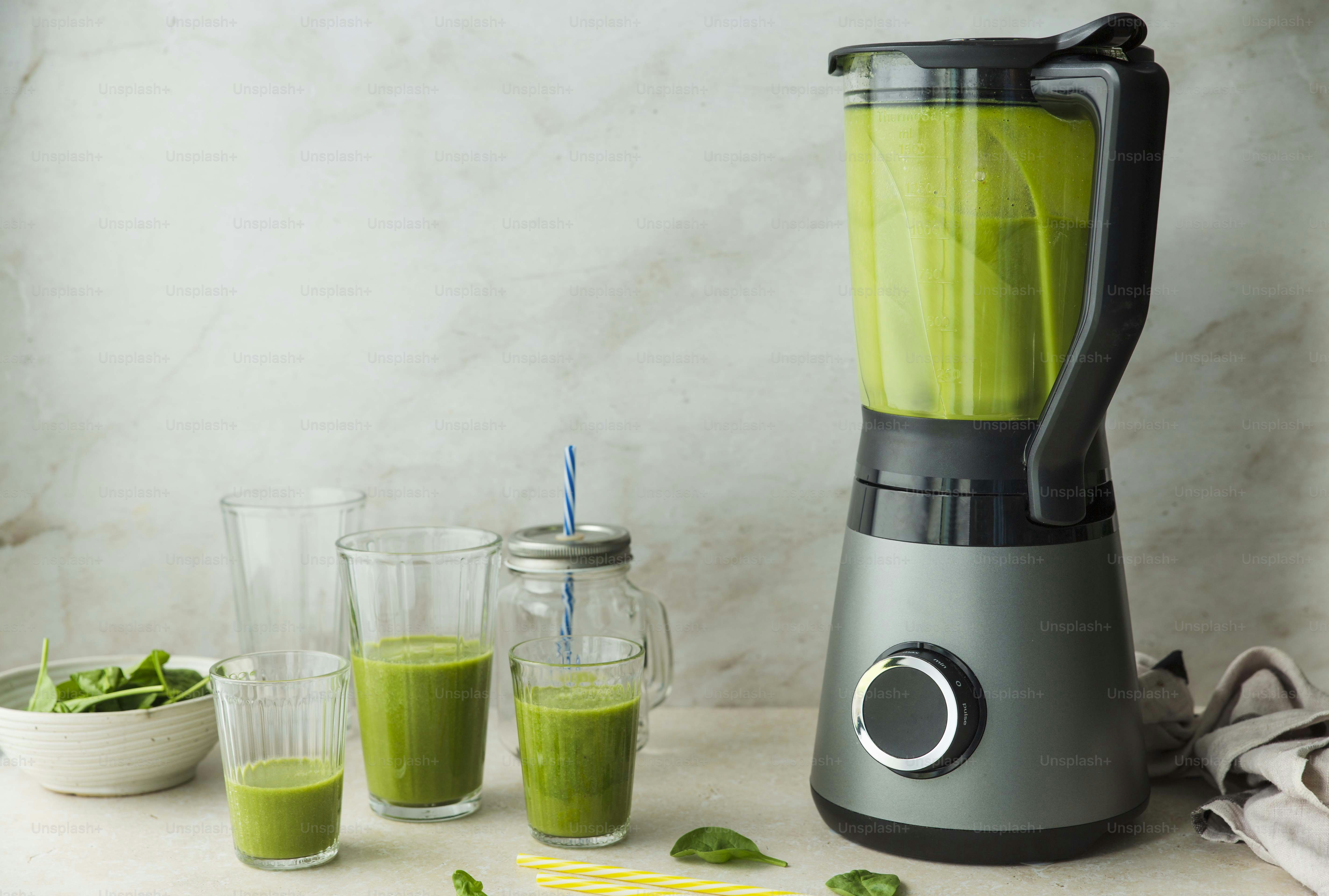 a blender with a green smoothie in it