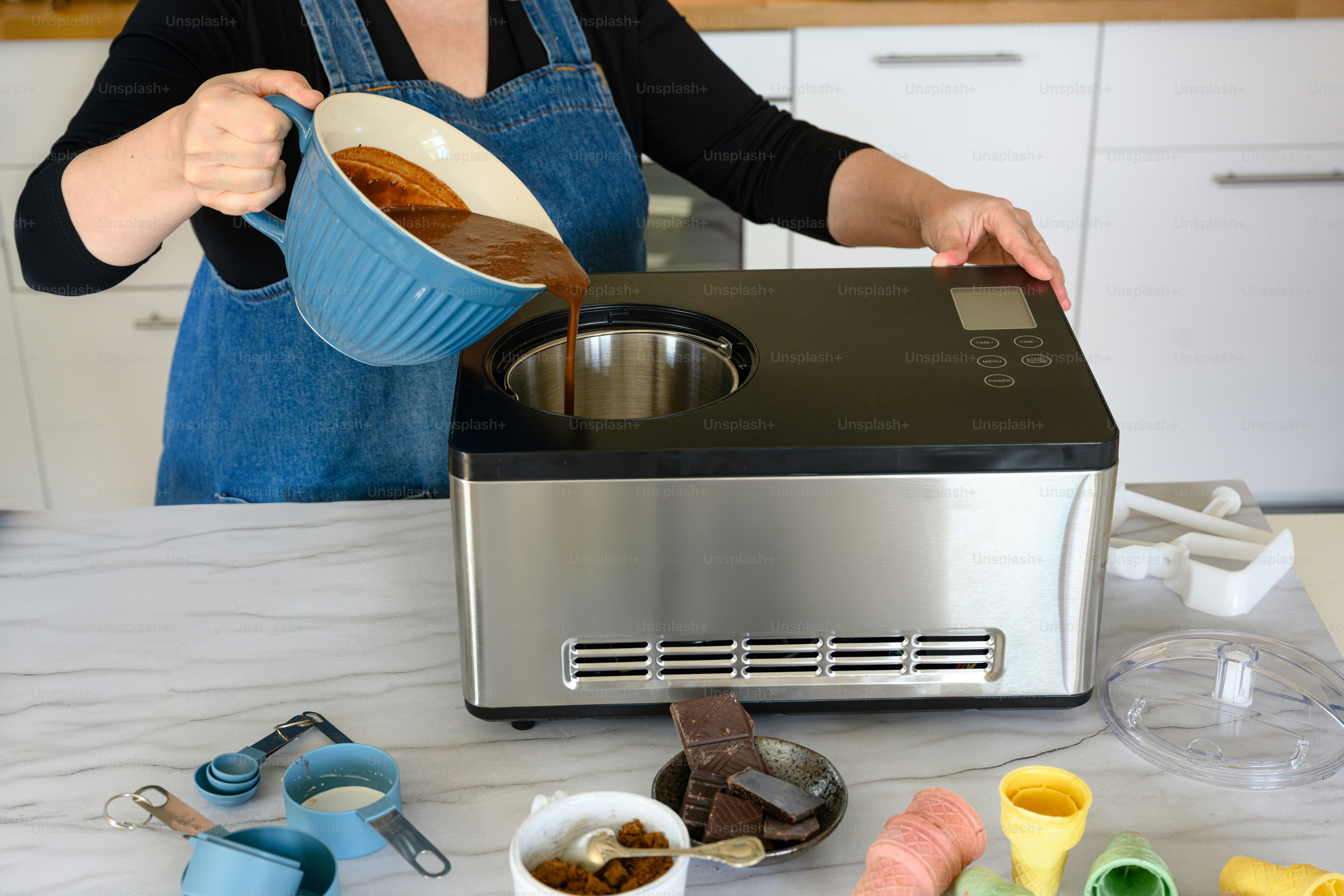 a woman pouring chocolate into a bowl