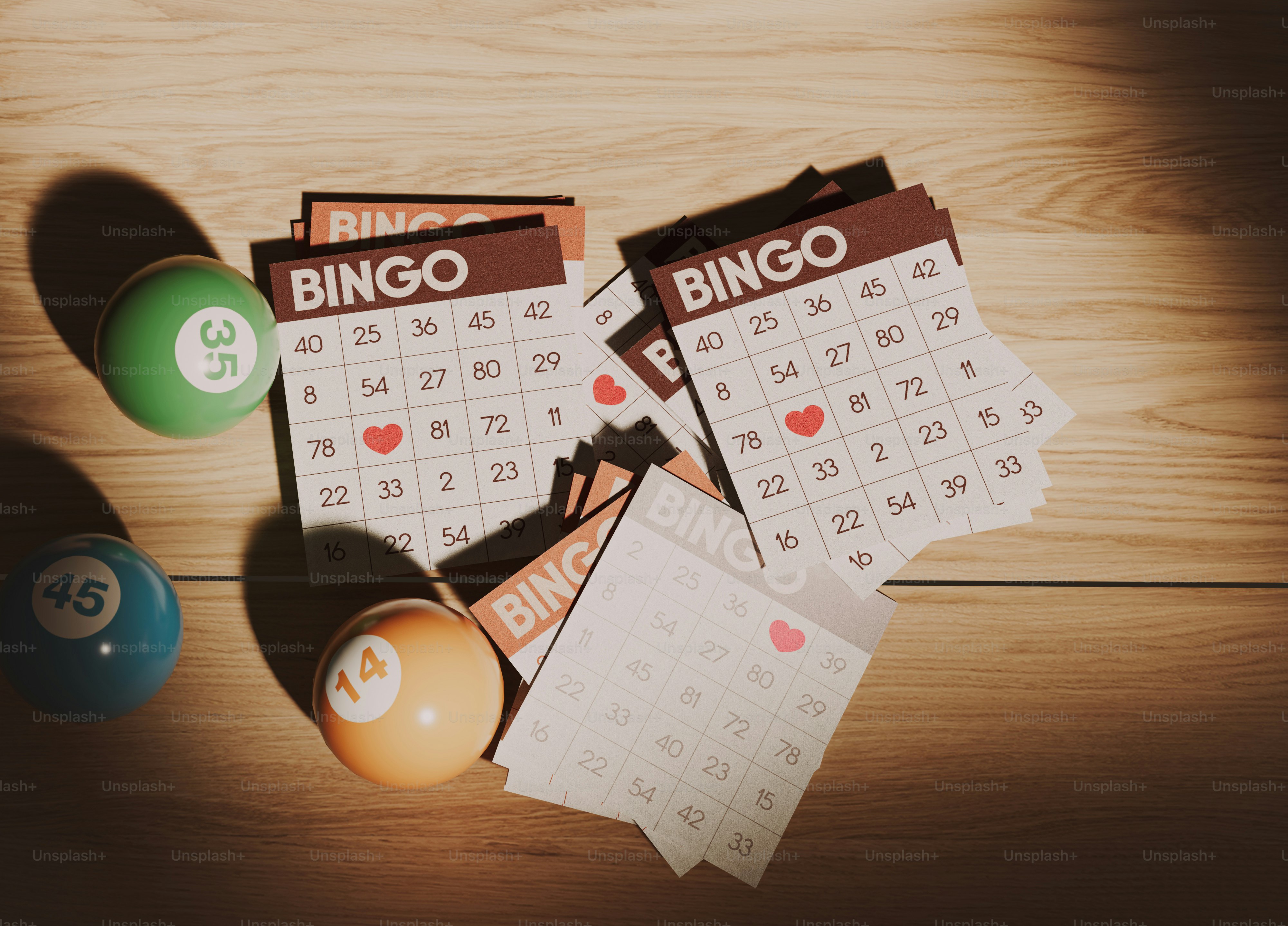 A wooden table topped with a calendar and pool balls photo – Bingo ...