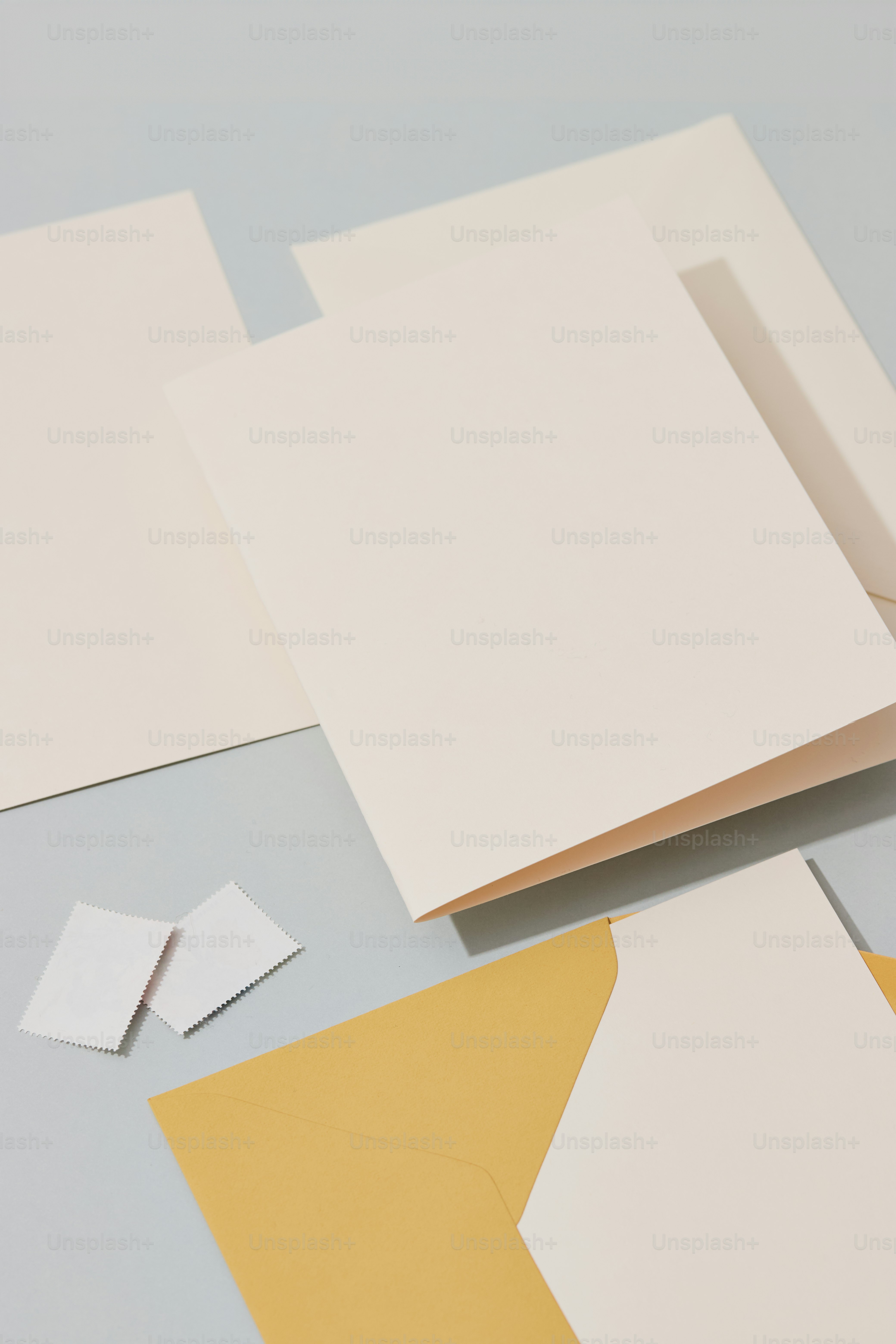 several pieces of paper and a pair of scissors on a table