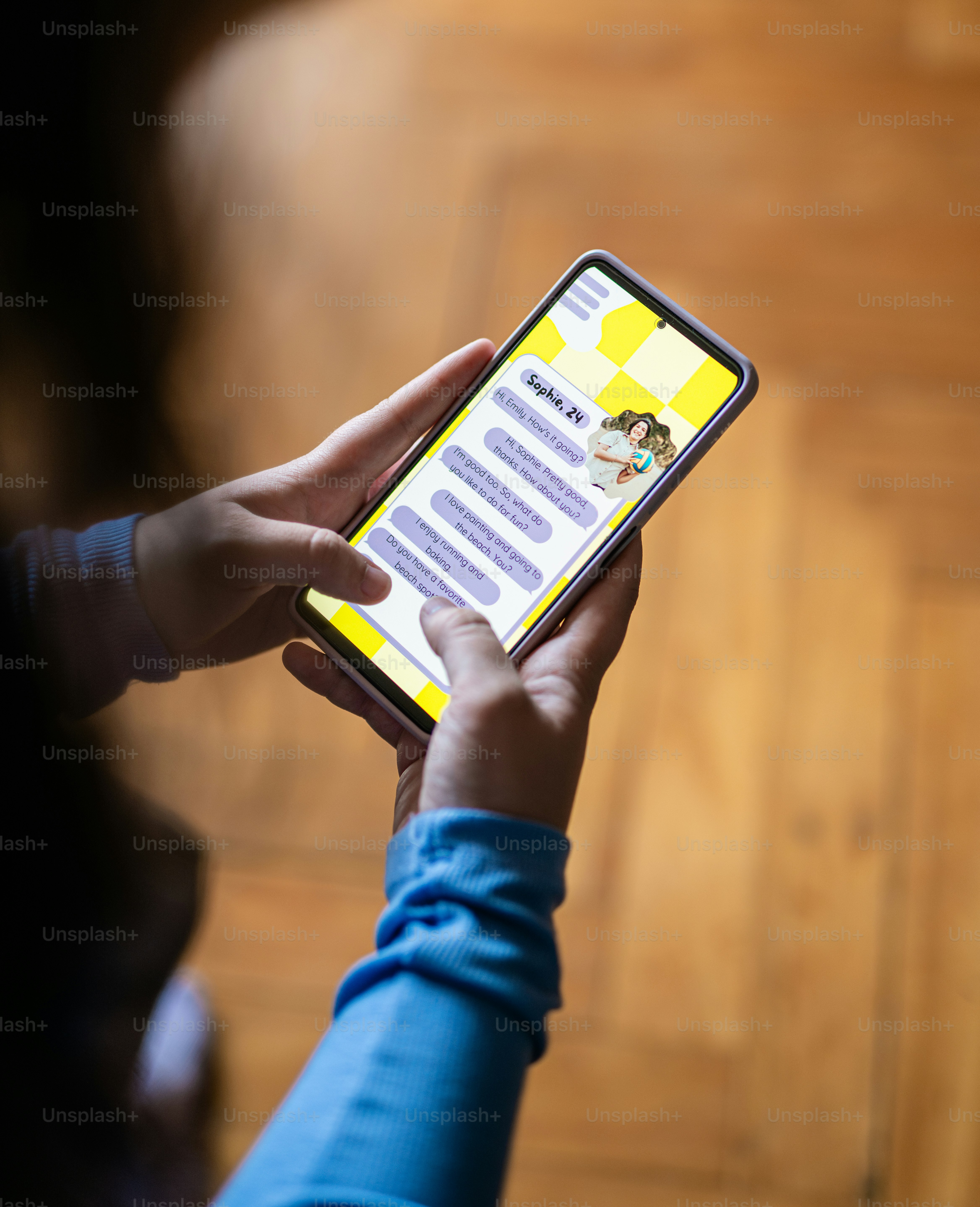 a person holding a cell phone in their hand