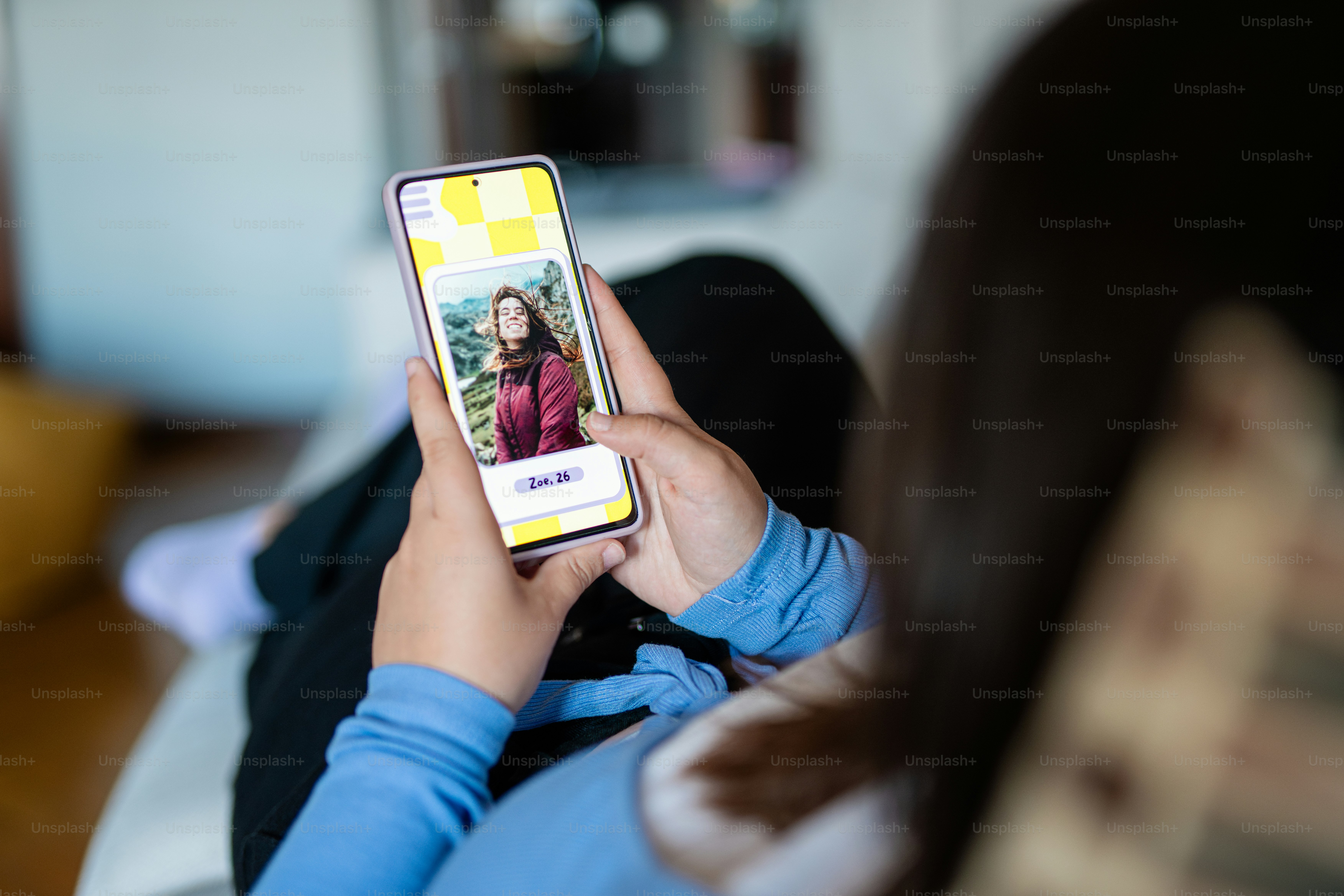 a woman holding a cell phone with a picture on it