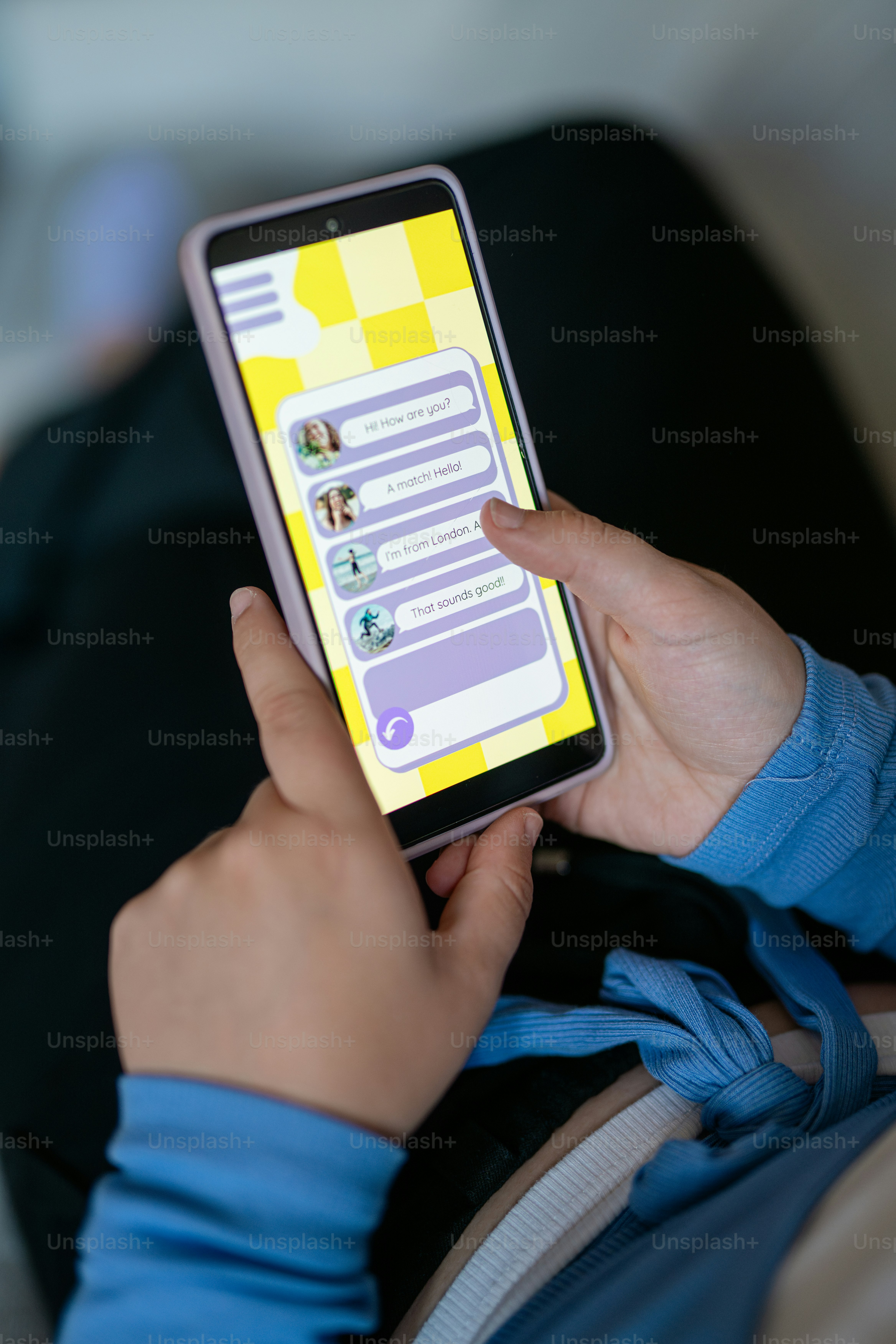 a person holding a cell phone with a yellow screen