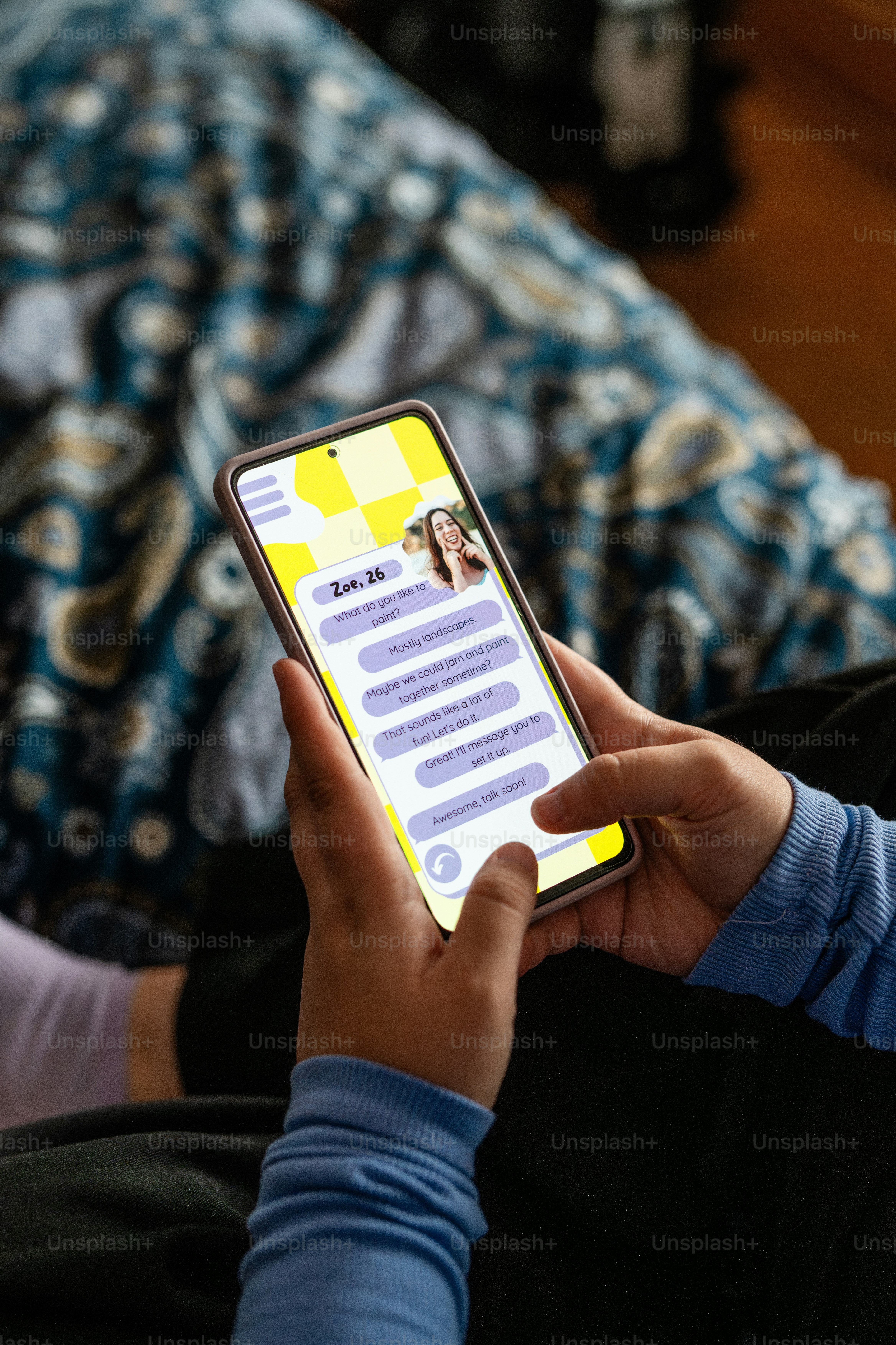 a person holding a cell phone with a yellow screen