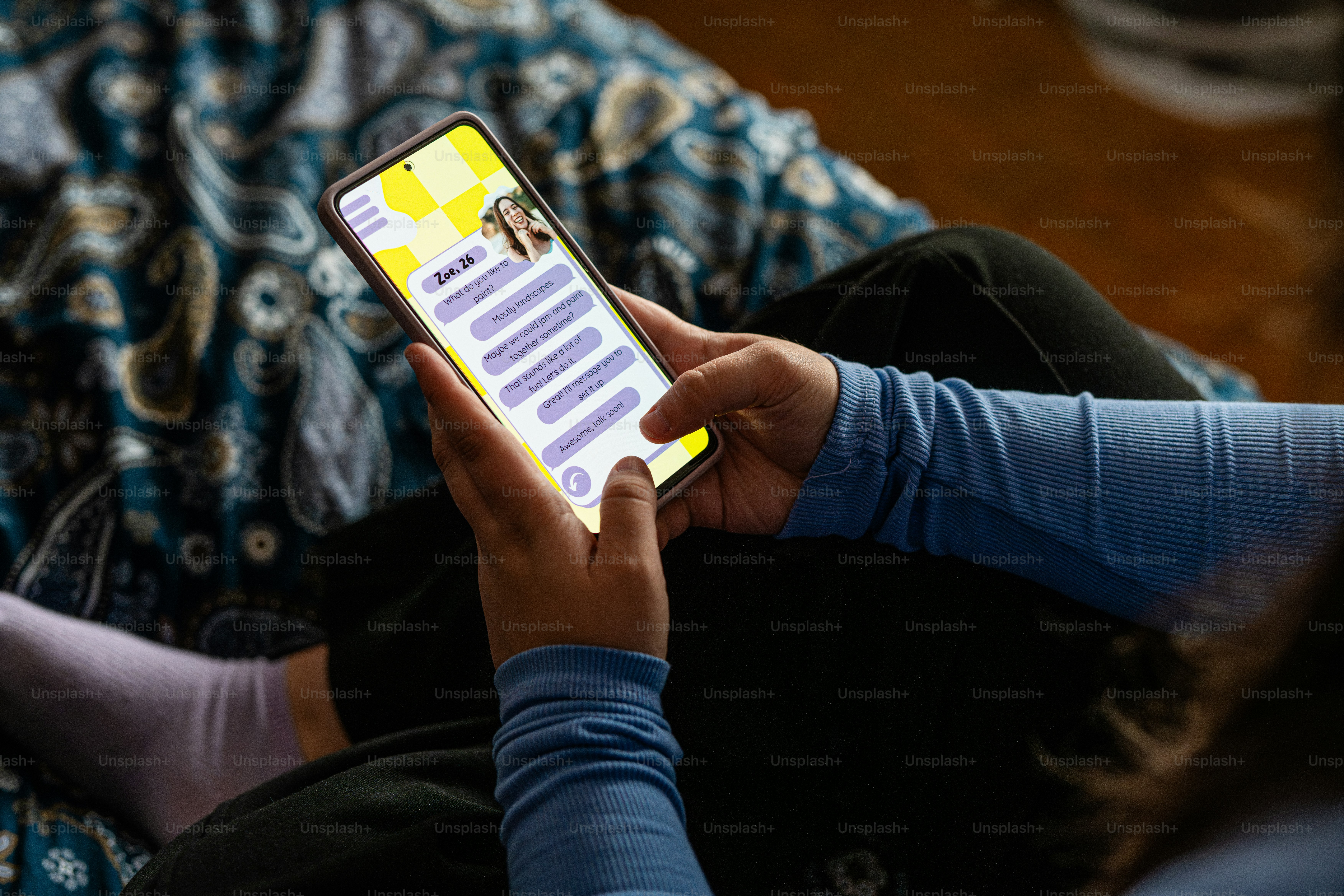 a person holding a cell phone in their hand