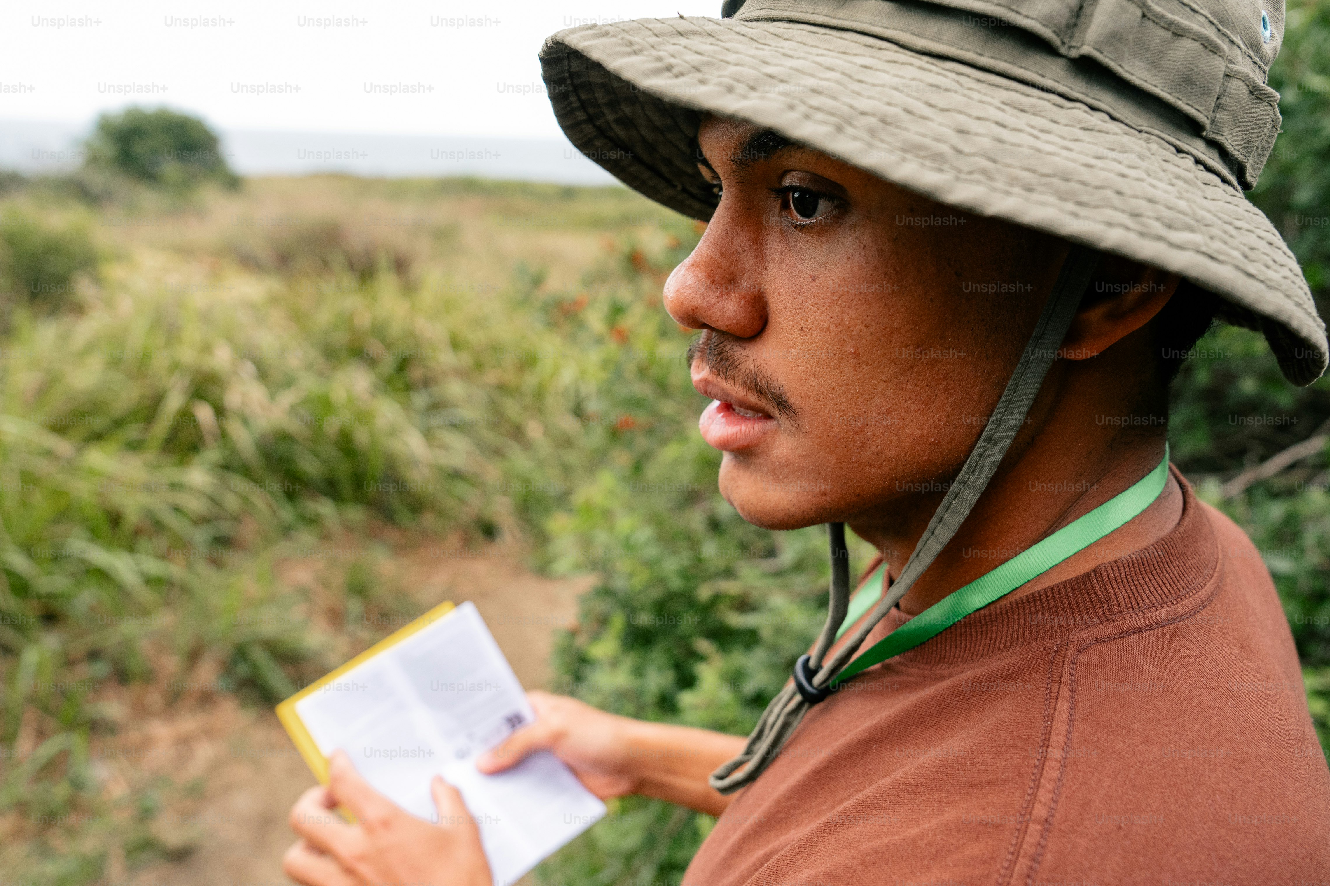 a man wearing a hat and holding a piece of paper