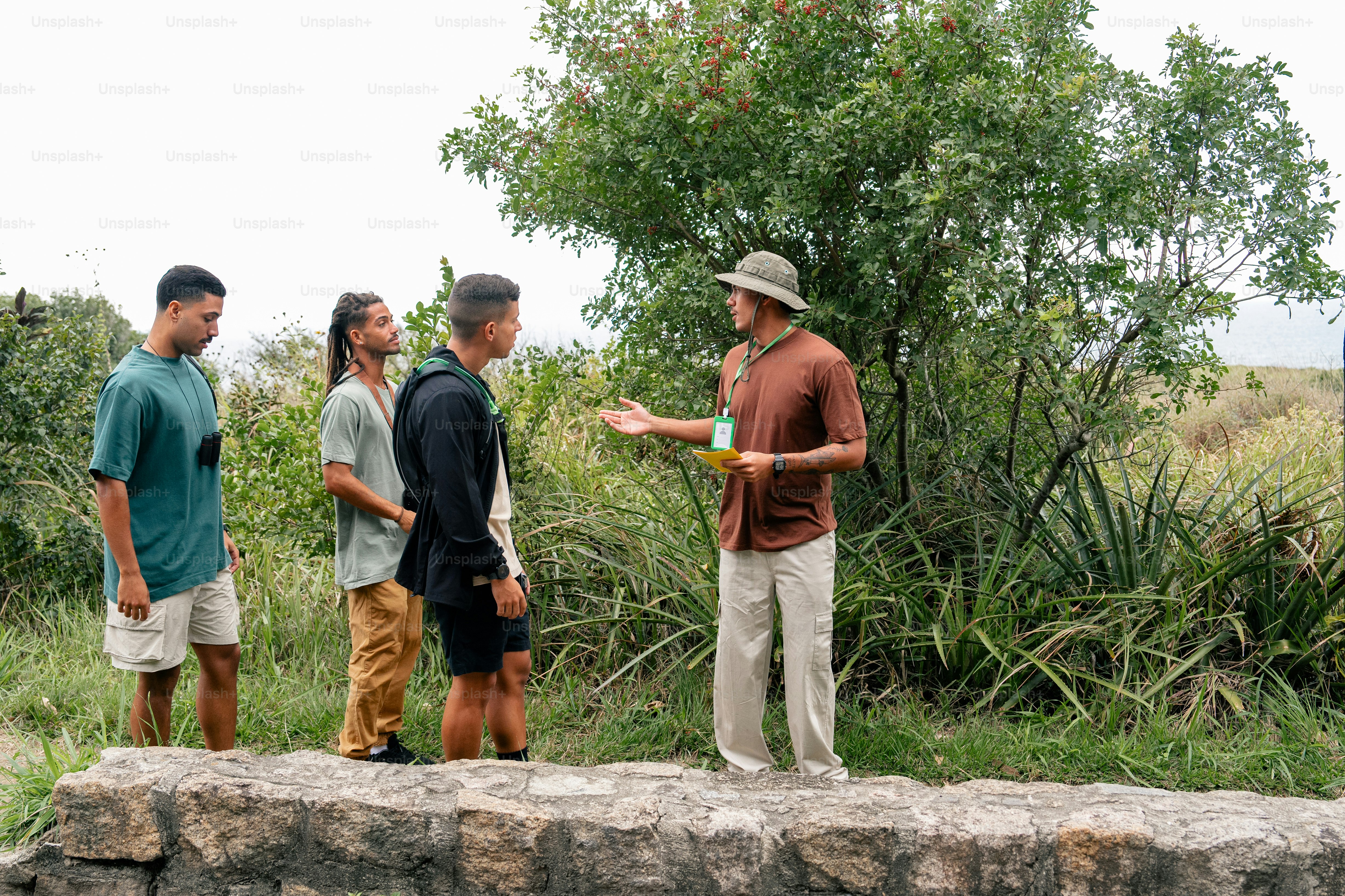 a group of men standing on top of a stone wall