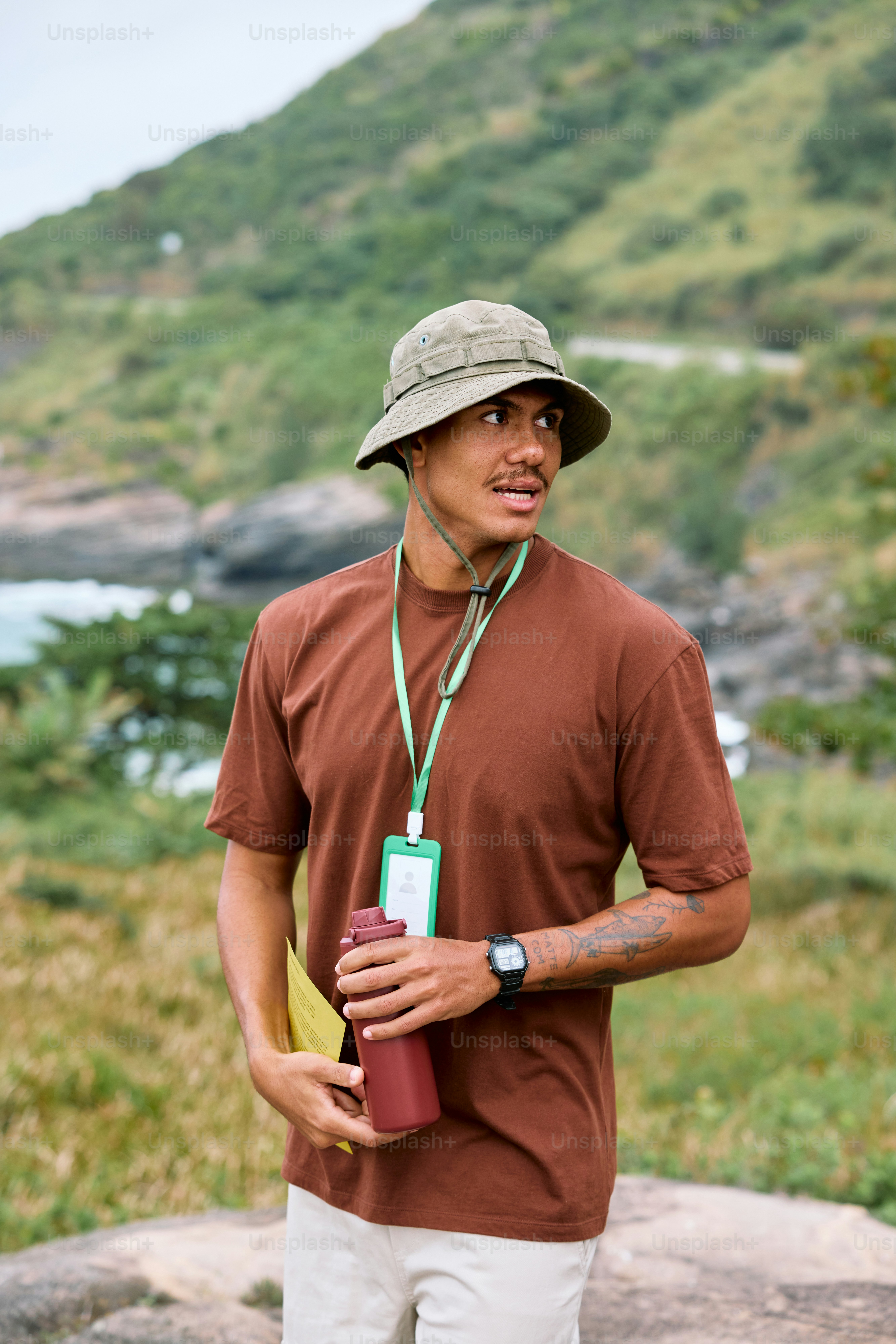 a man wearing a hat and holding a water bottle