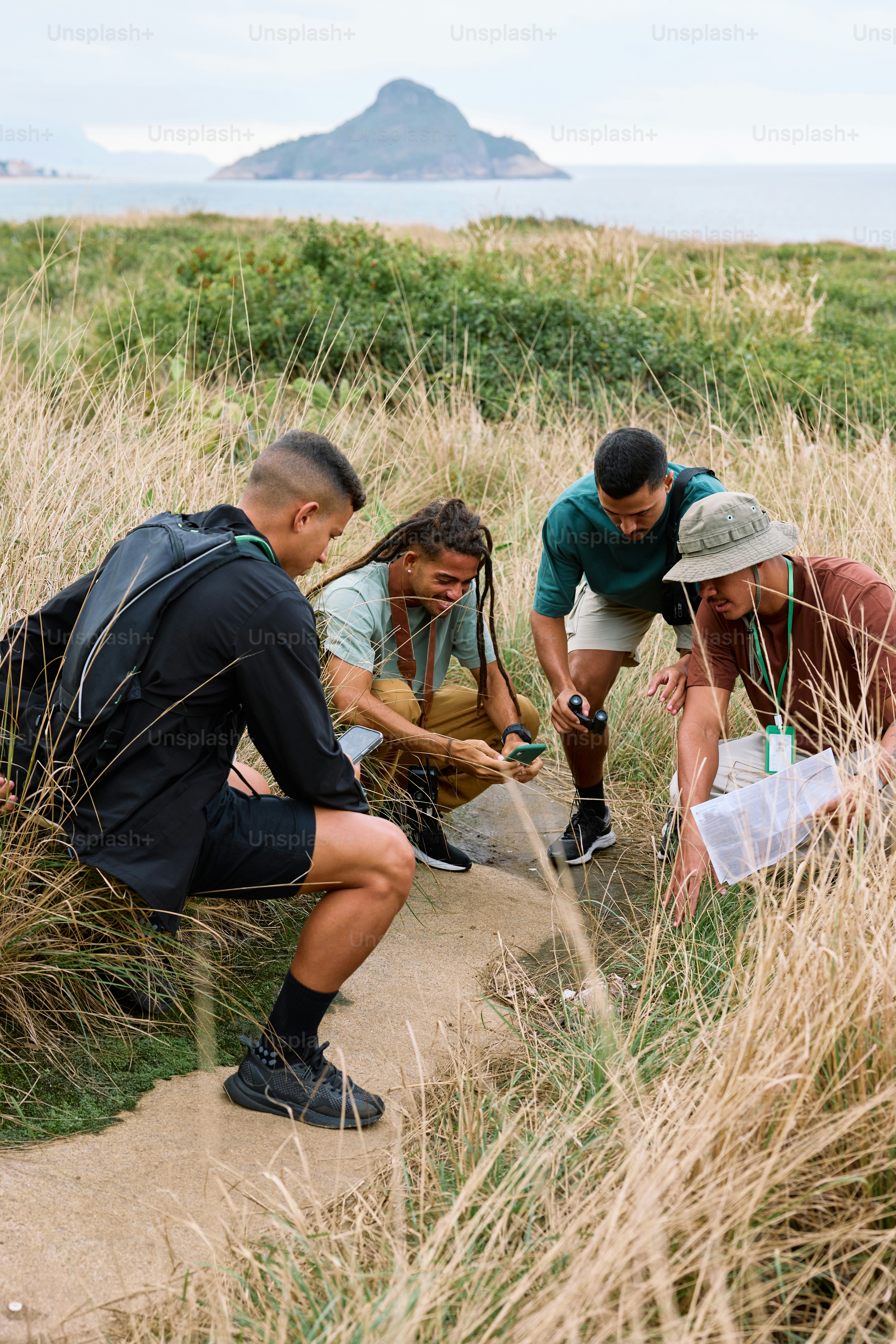a group of people standing on top of a grass covered field
