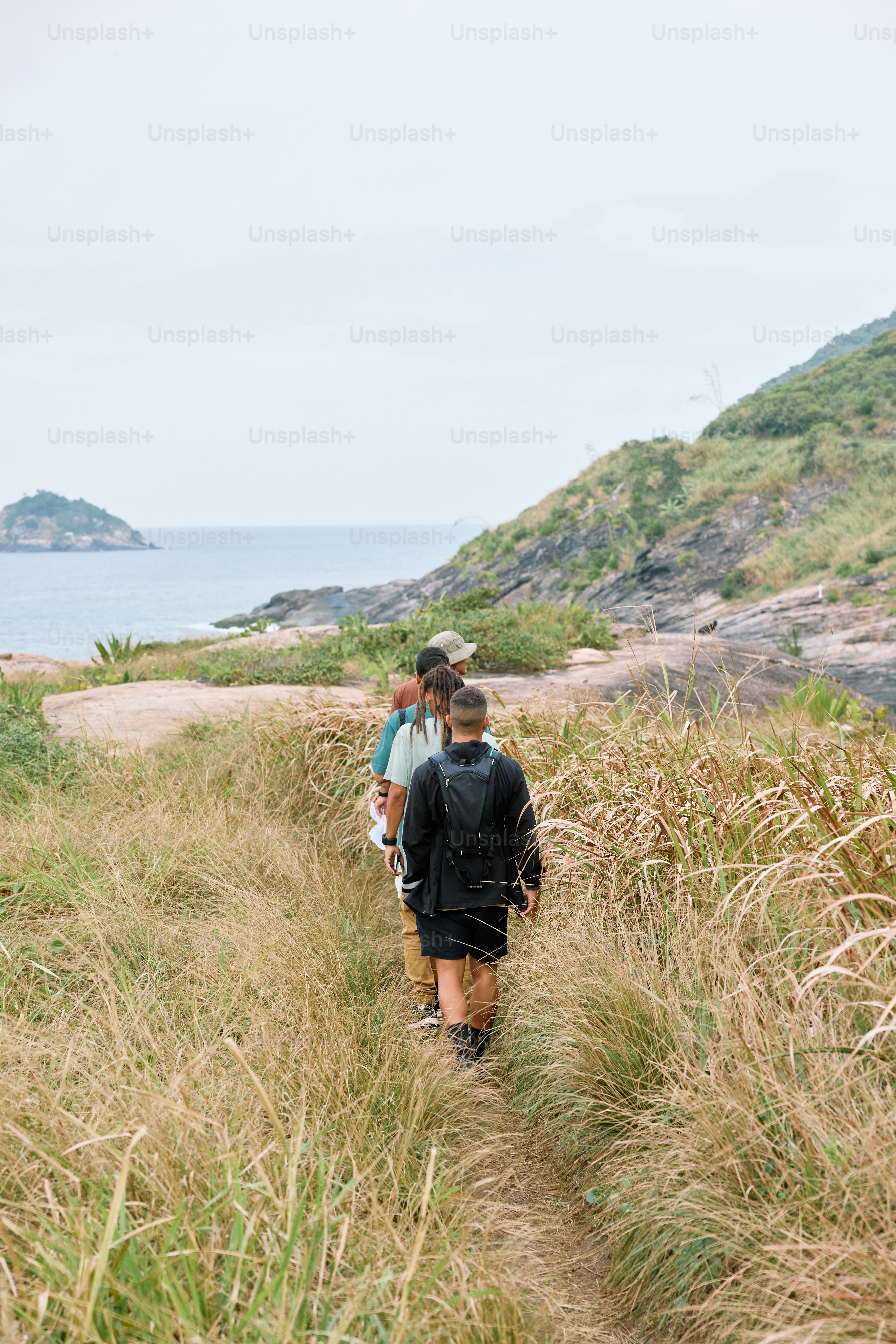 a couple of people that are walking in the grass