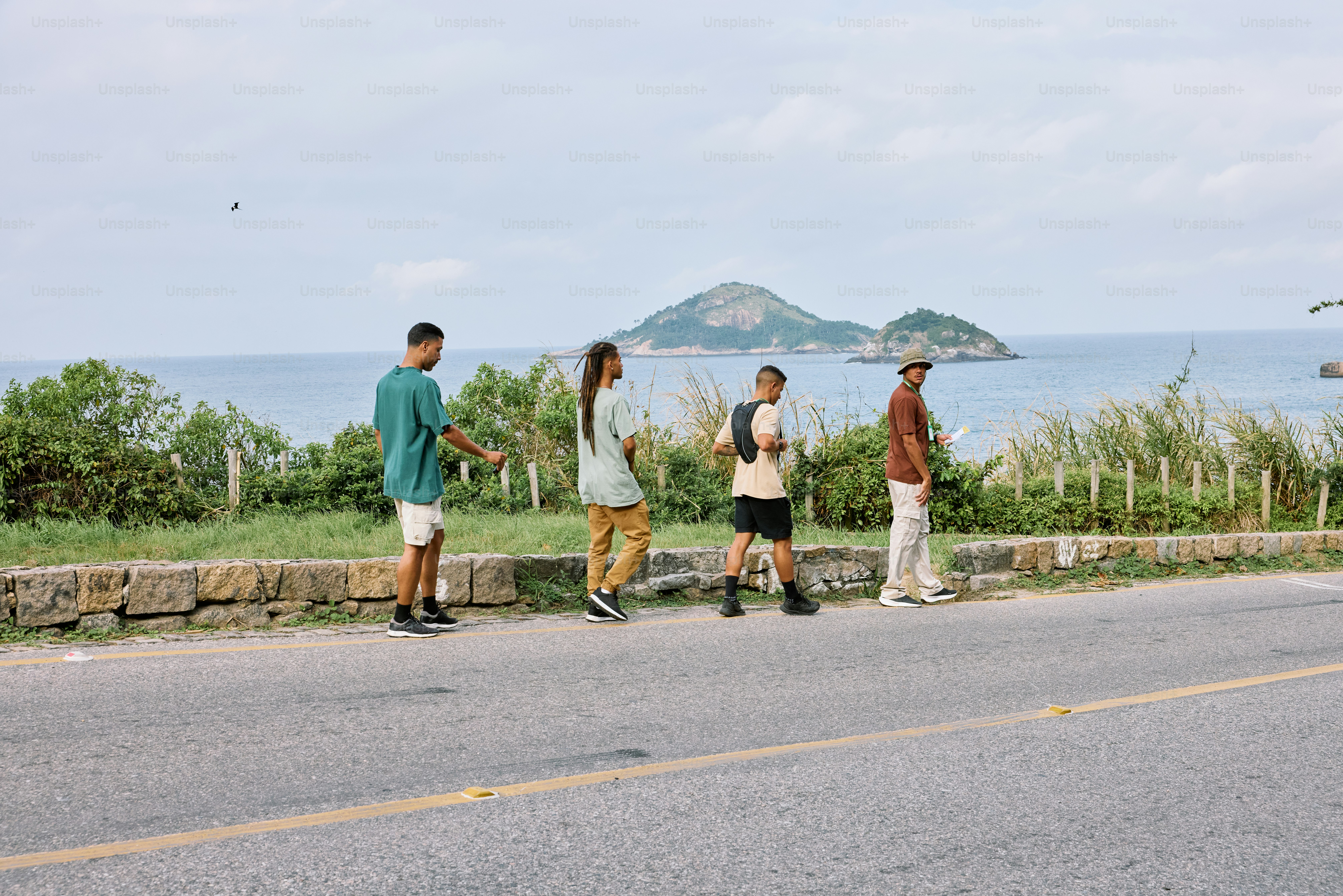a group of people standing on the side of a road