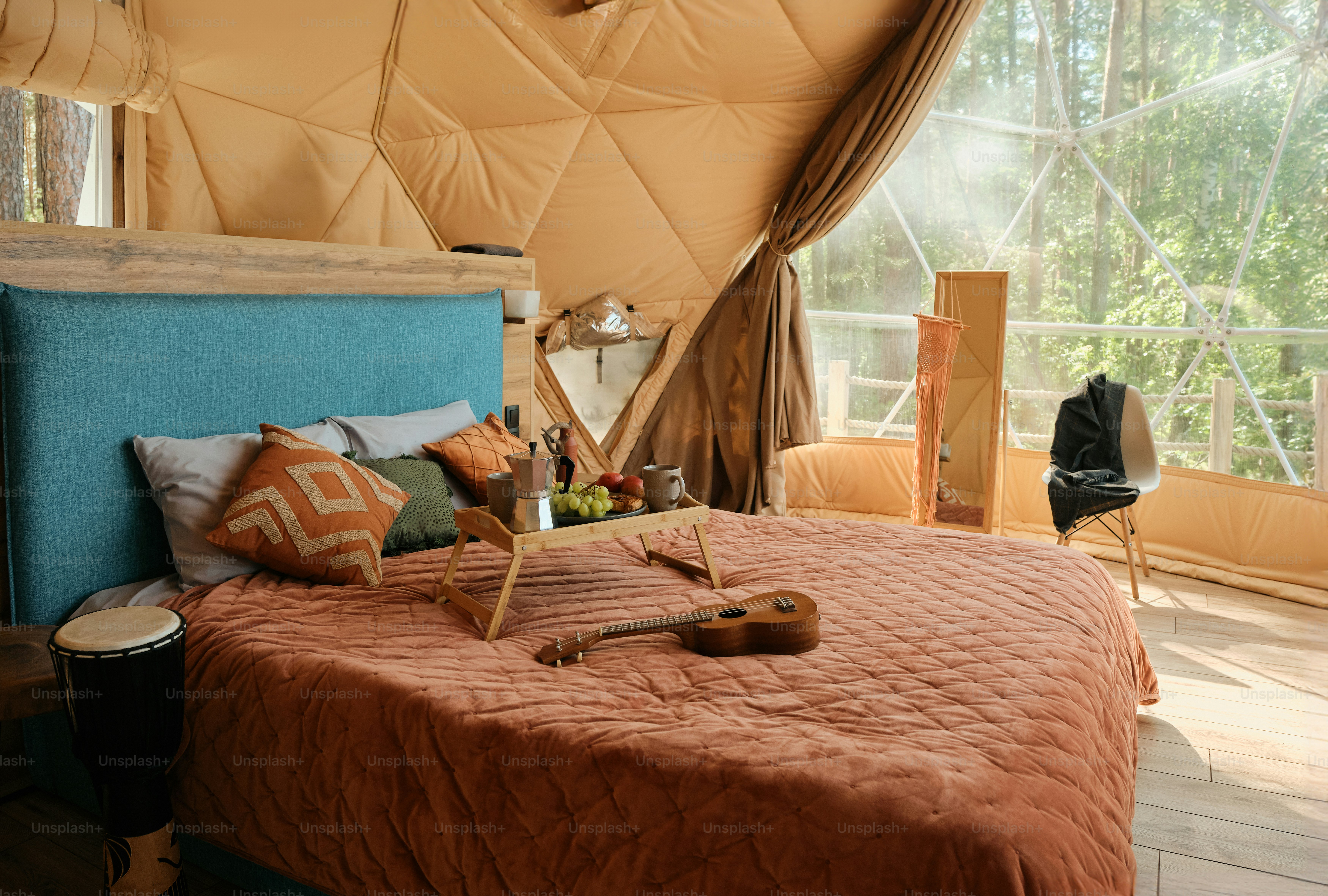 tempat tidur di tenda dengan nampan makanan di atasnya