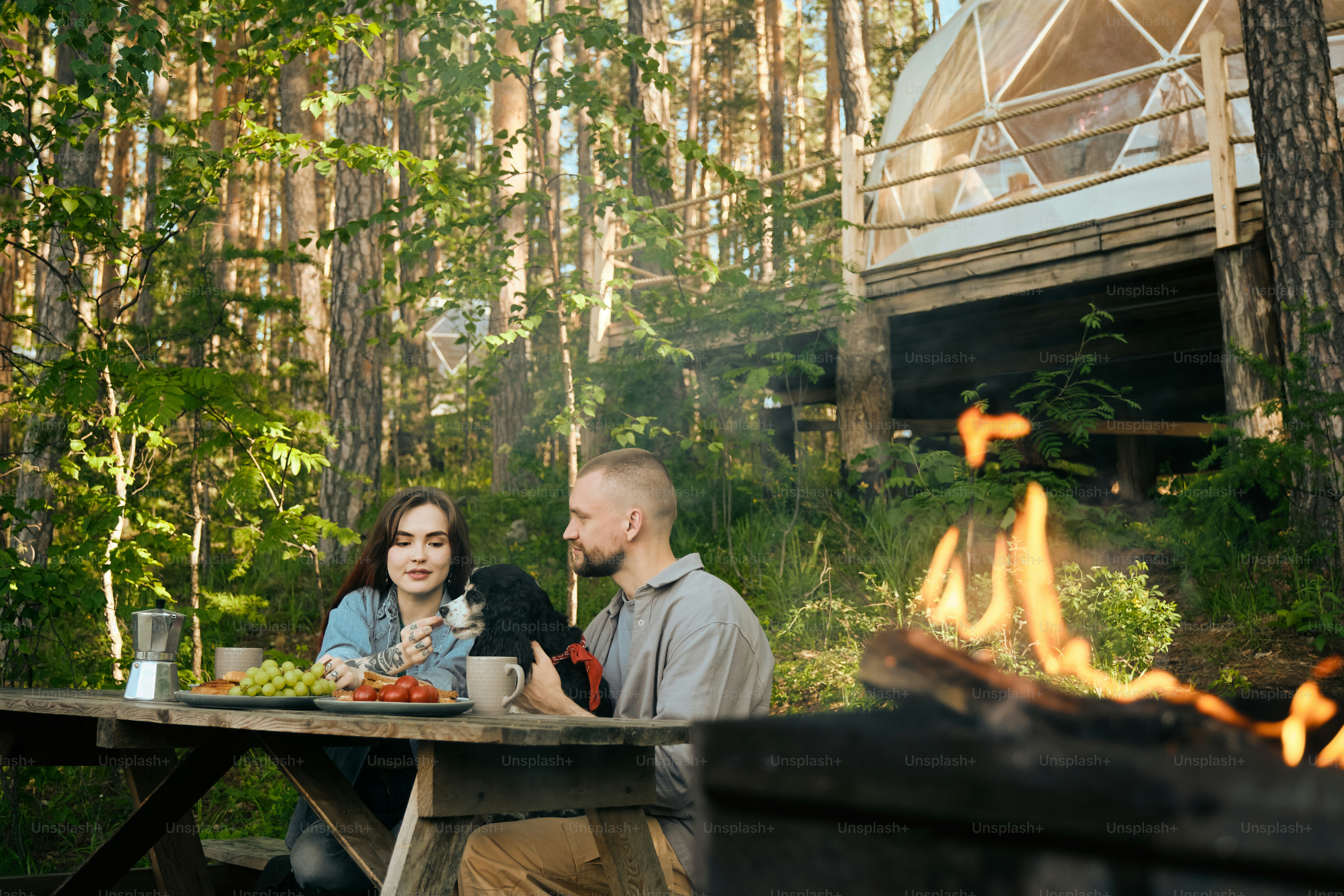 a man and a woman sitting at a picnic table