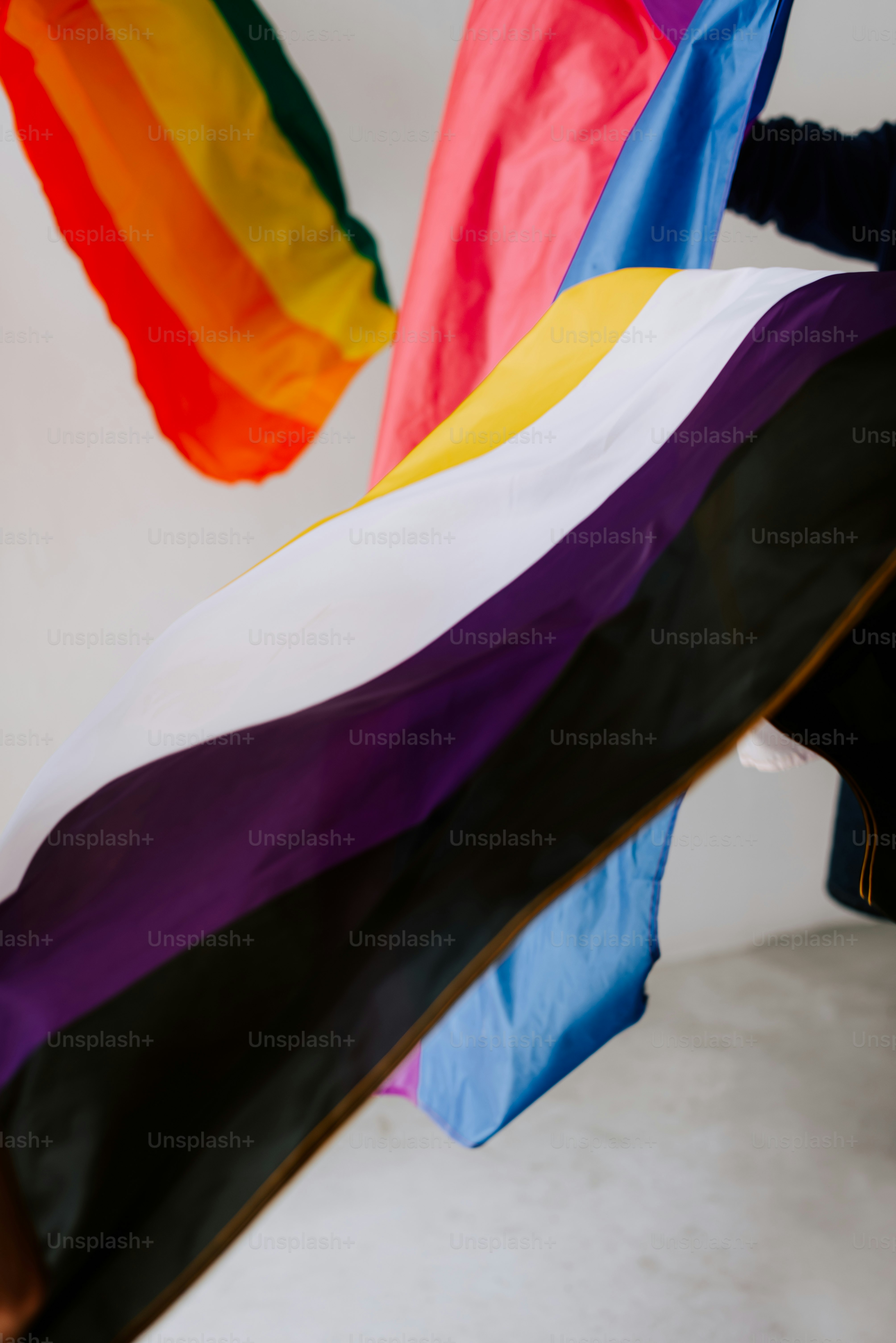 a woman holding a rainbow flag in her hands