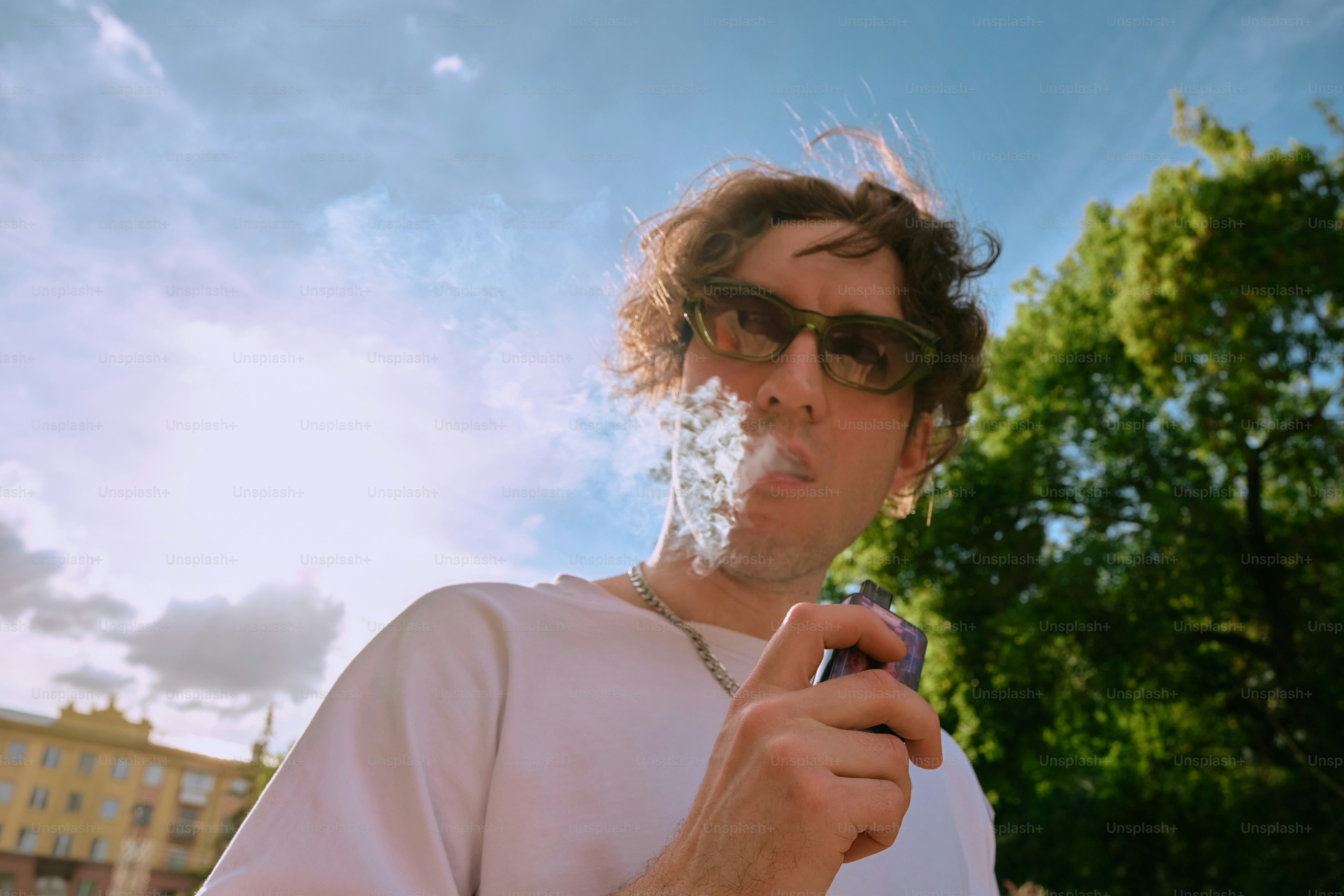 a man in sunglasses smokes a cigarette