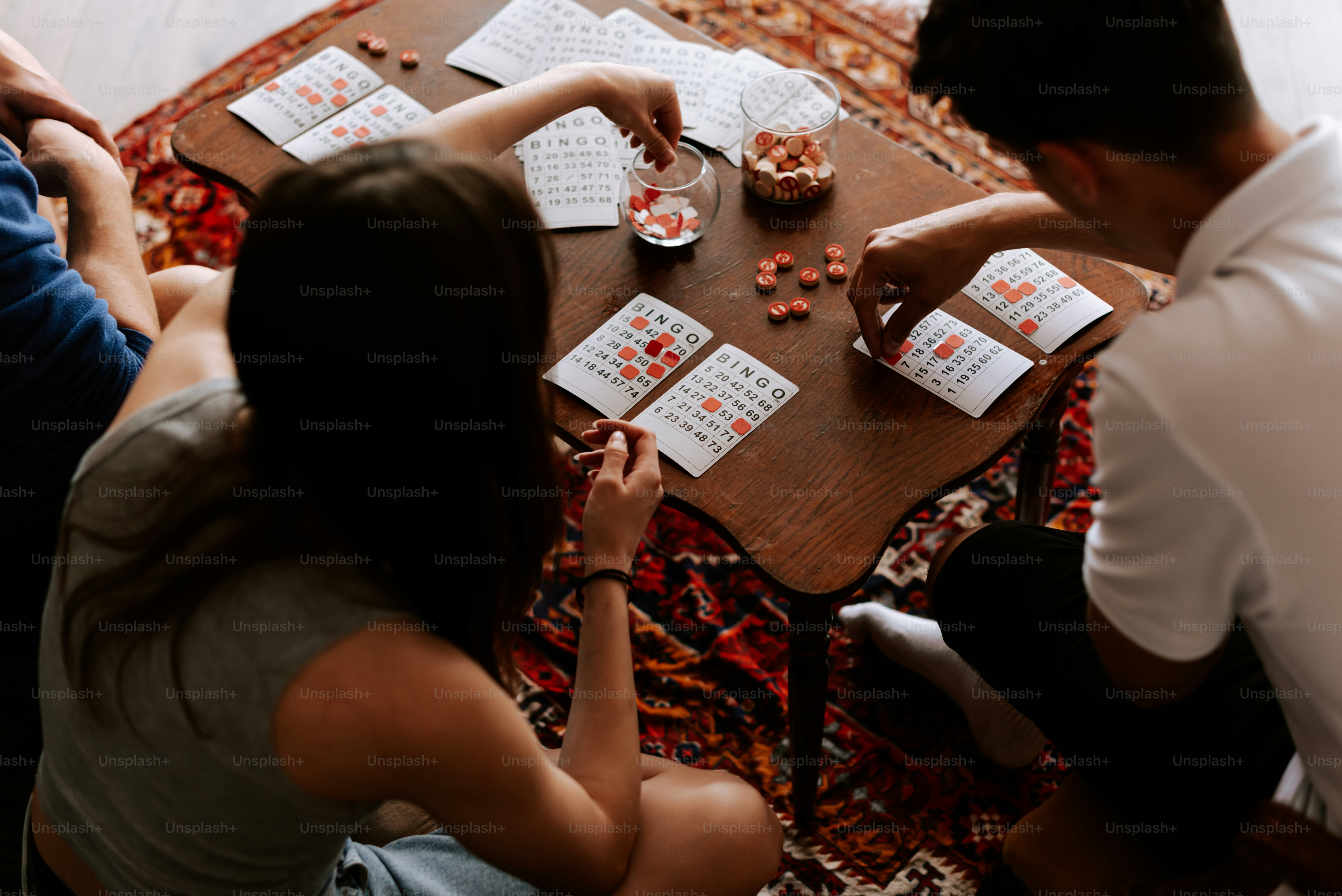 a group of people sitting around a wooden table