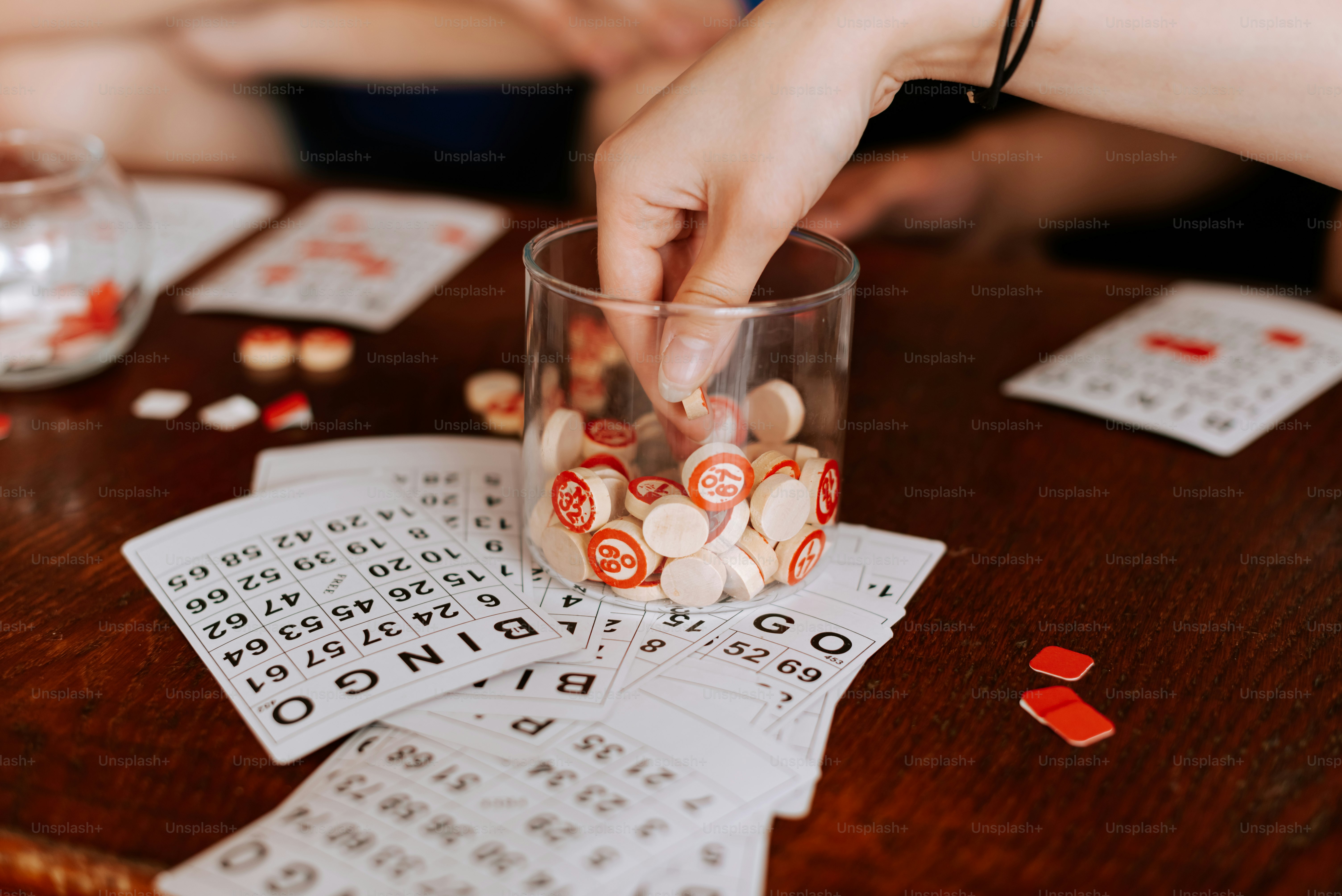 a close up of a person placing dices in a glass