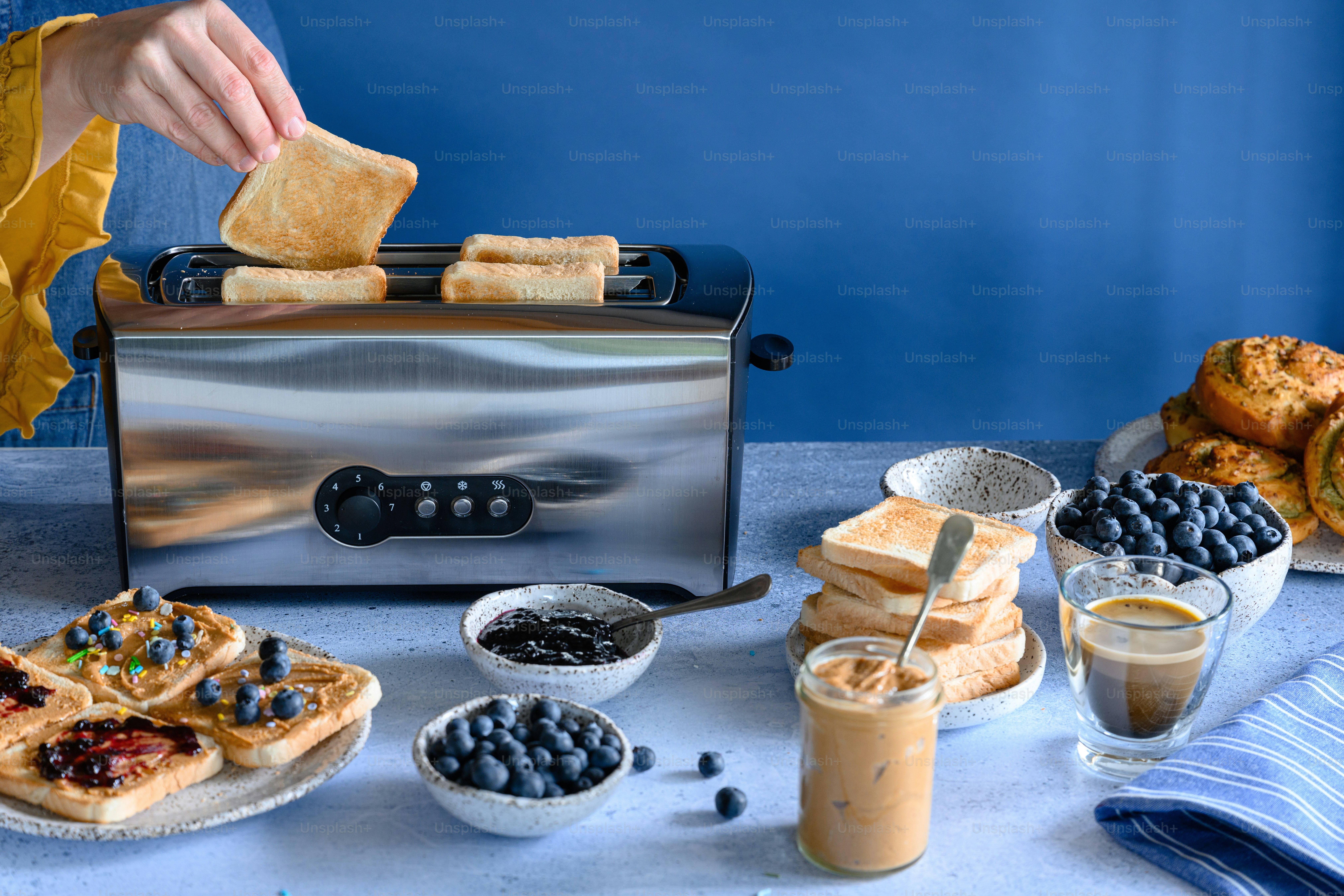 A table topped with plates of food and a toaster