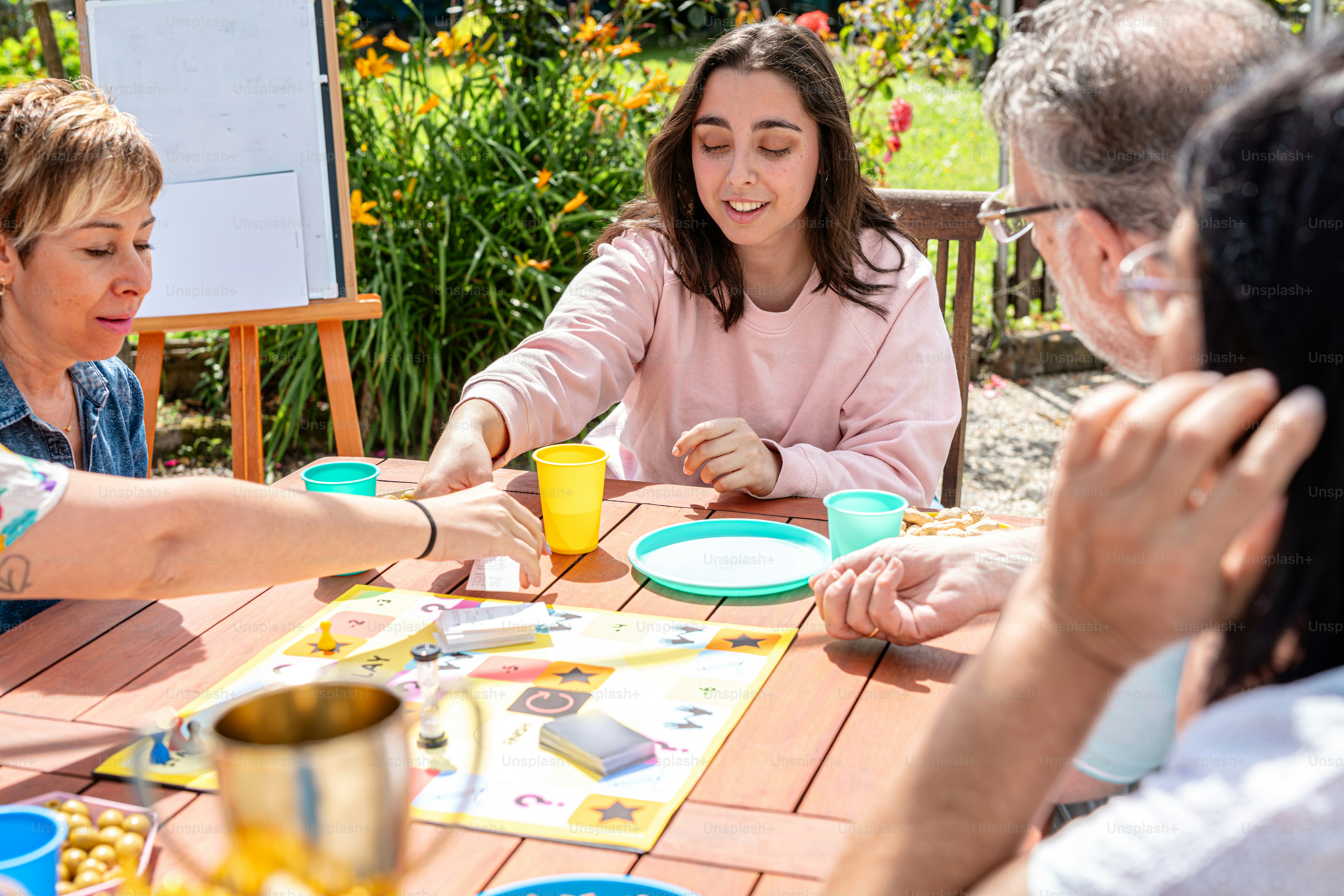 a group of people sitting around a wooden table