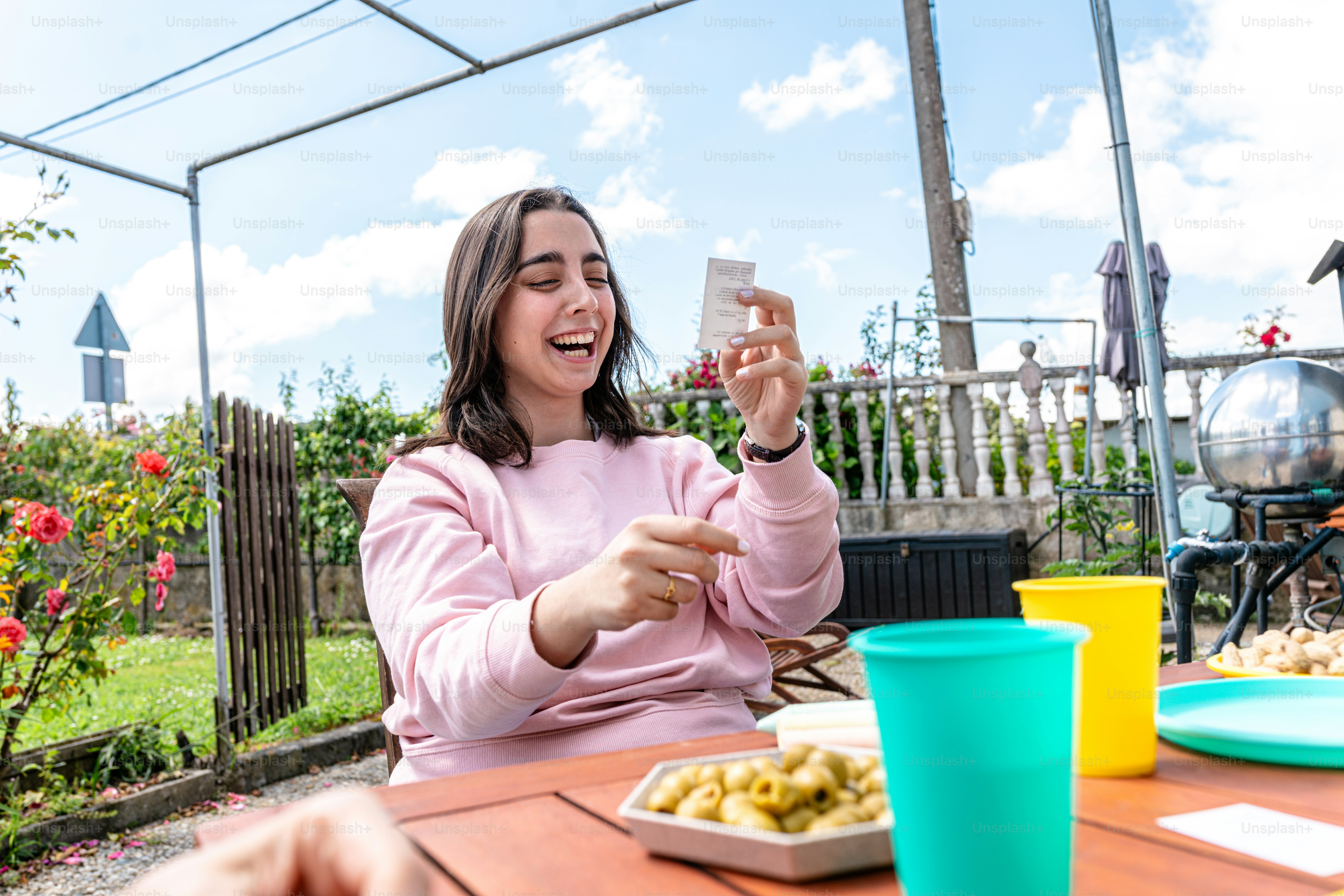 a woman sitting at a table with a plate of food