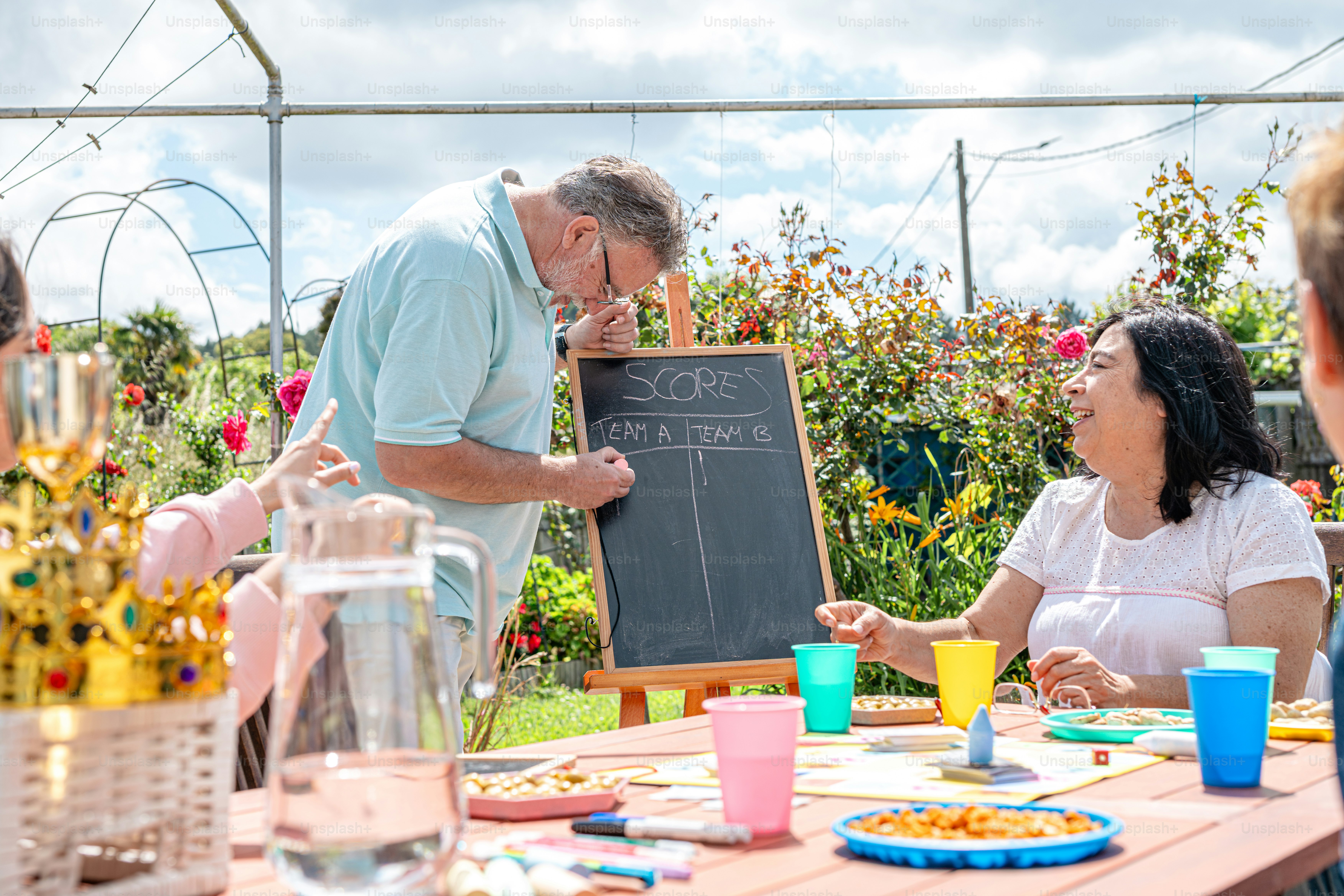 a group of people sitting around a table with food