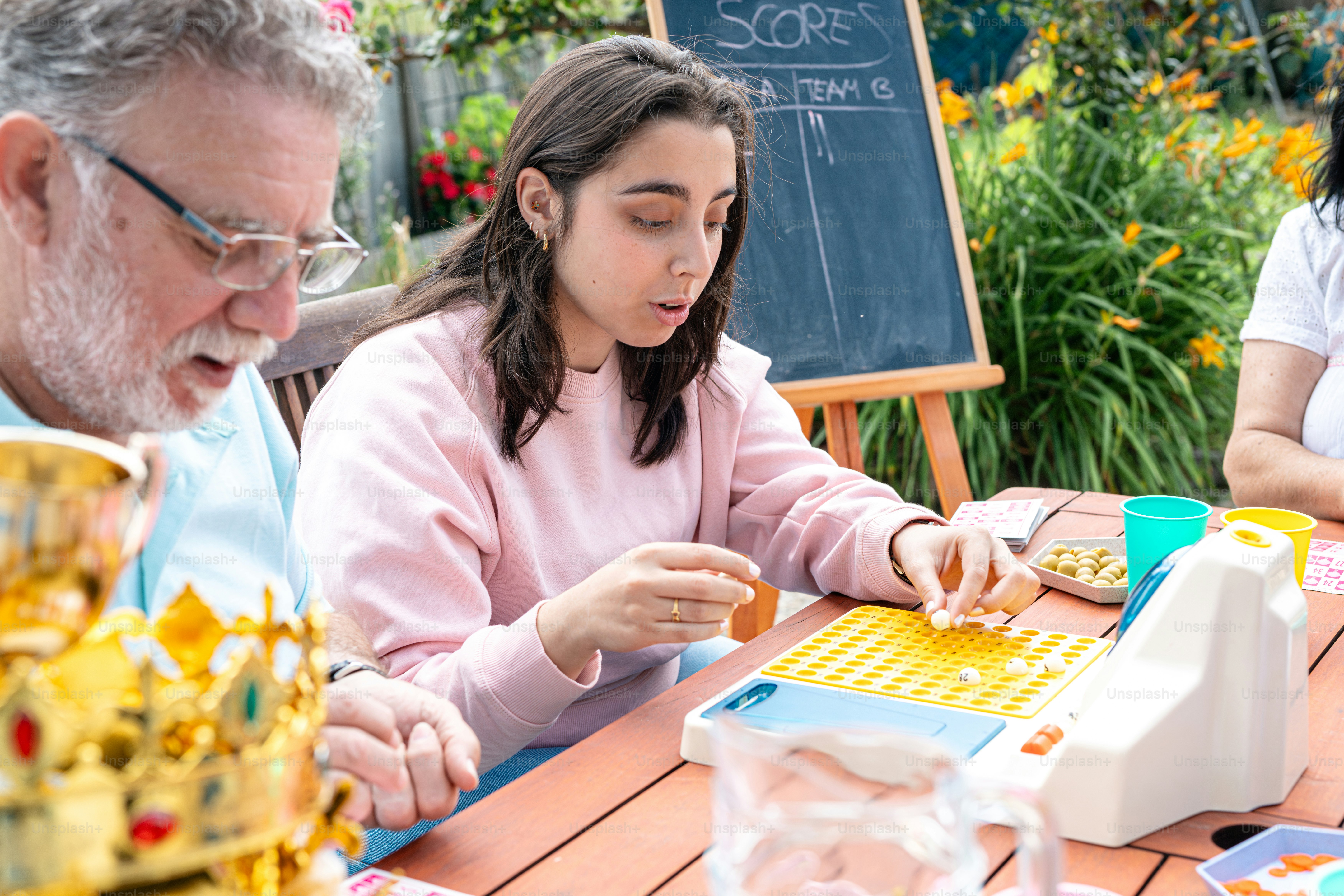 a man and a woman sitting at a table playing a board game