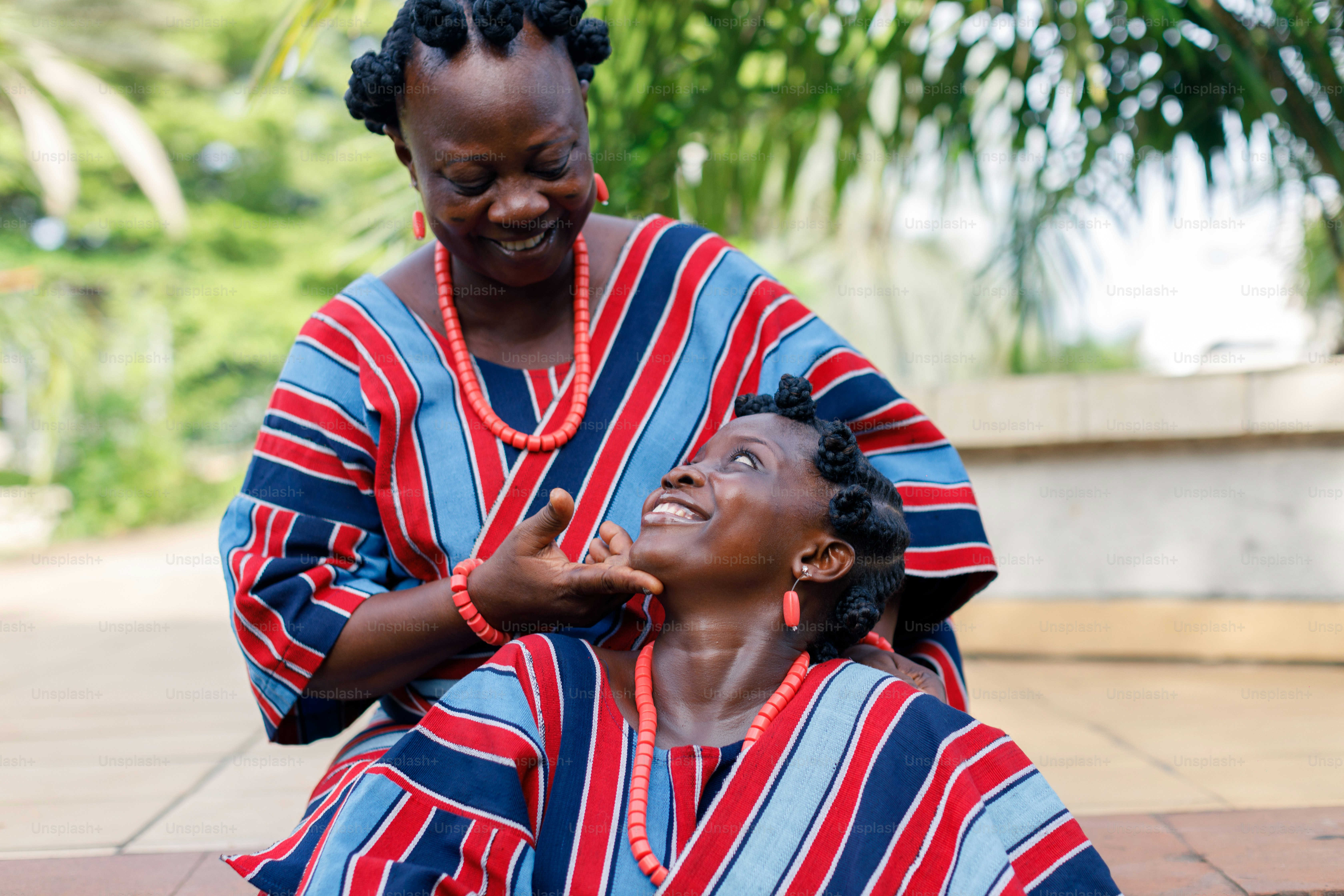 a woman sitting next to a statue of a woman
