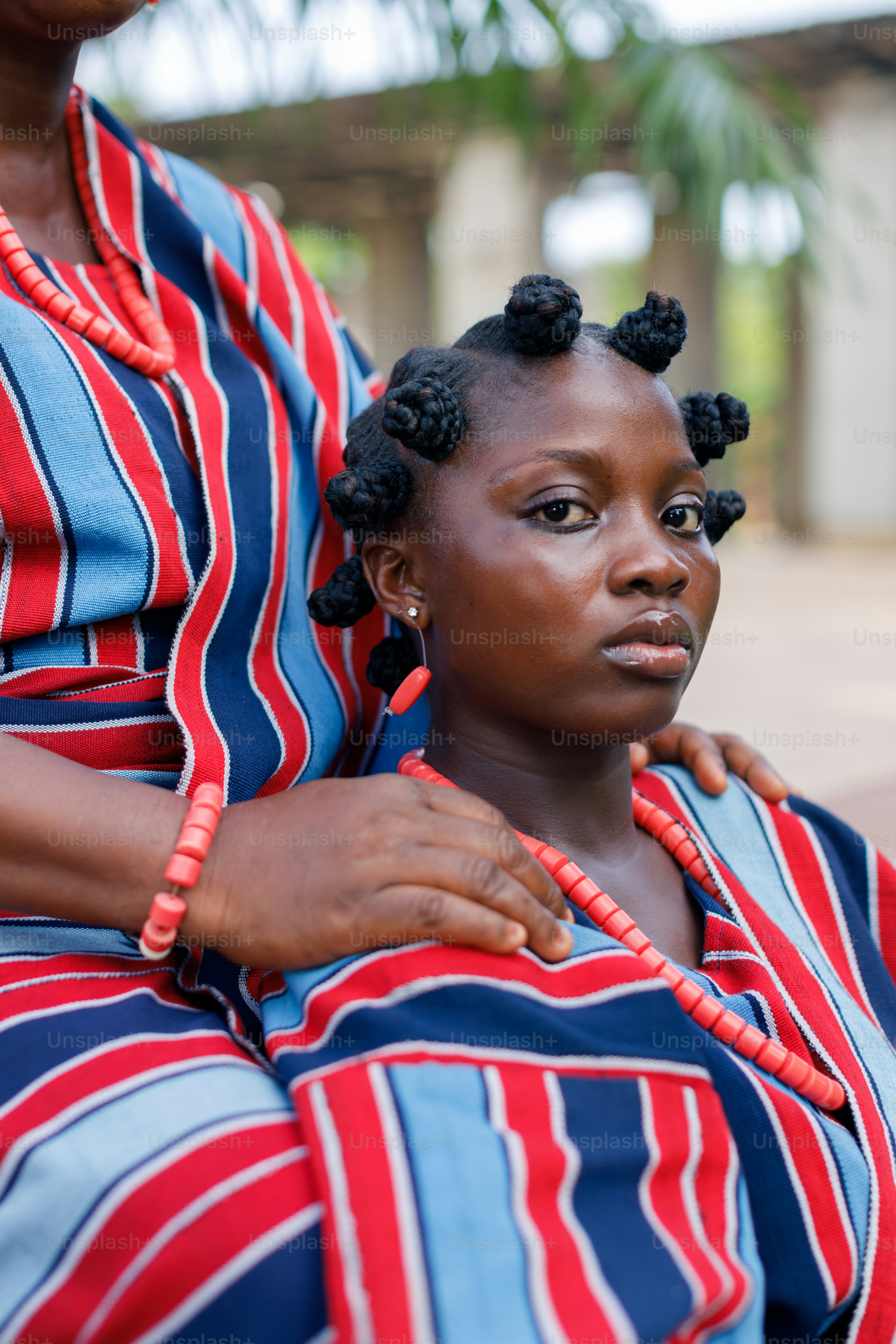 a woman is holding another woman's shoulder