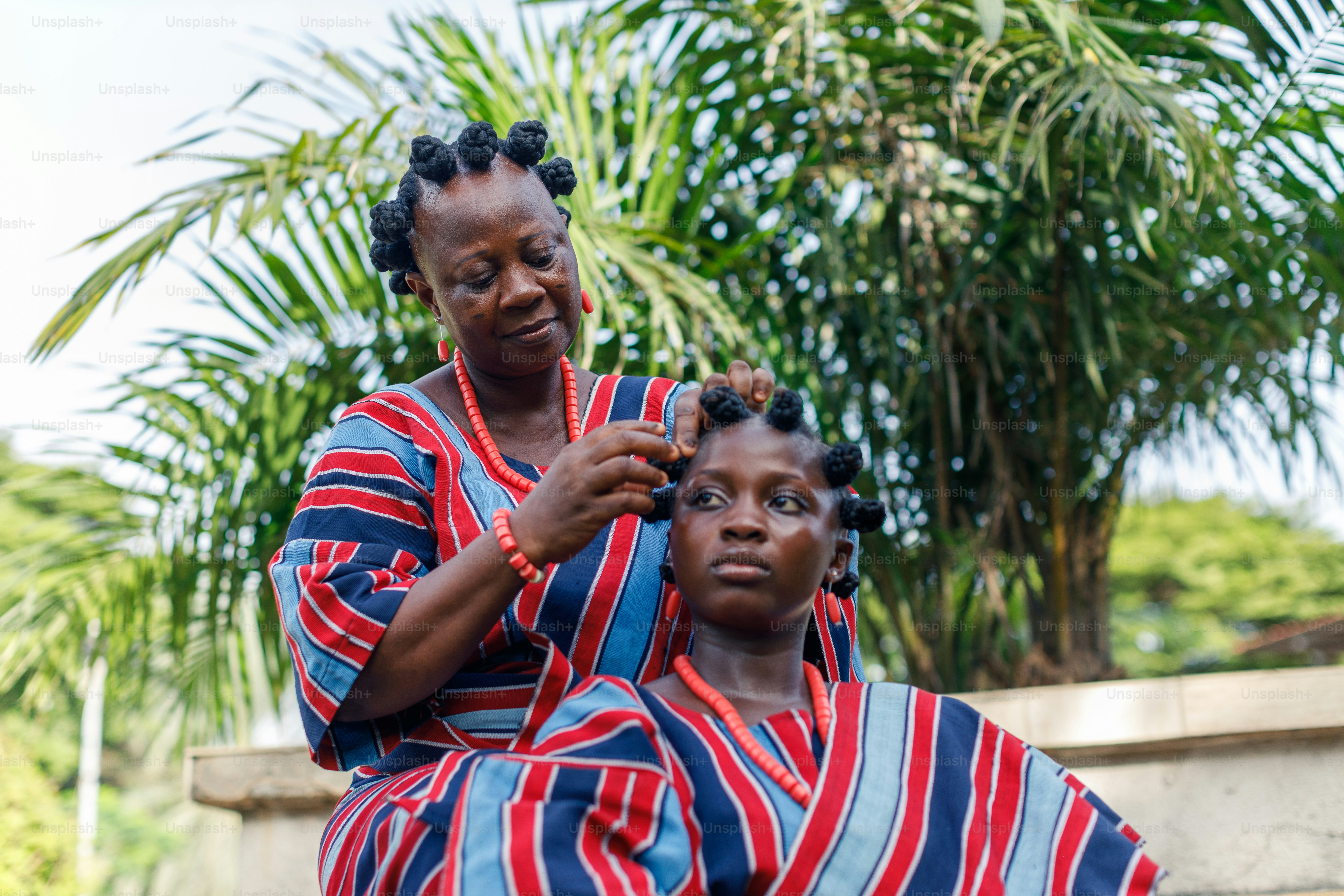 a woman is cutting another woman's hair