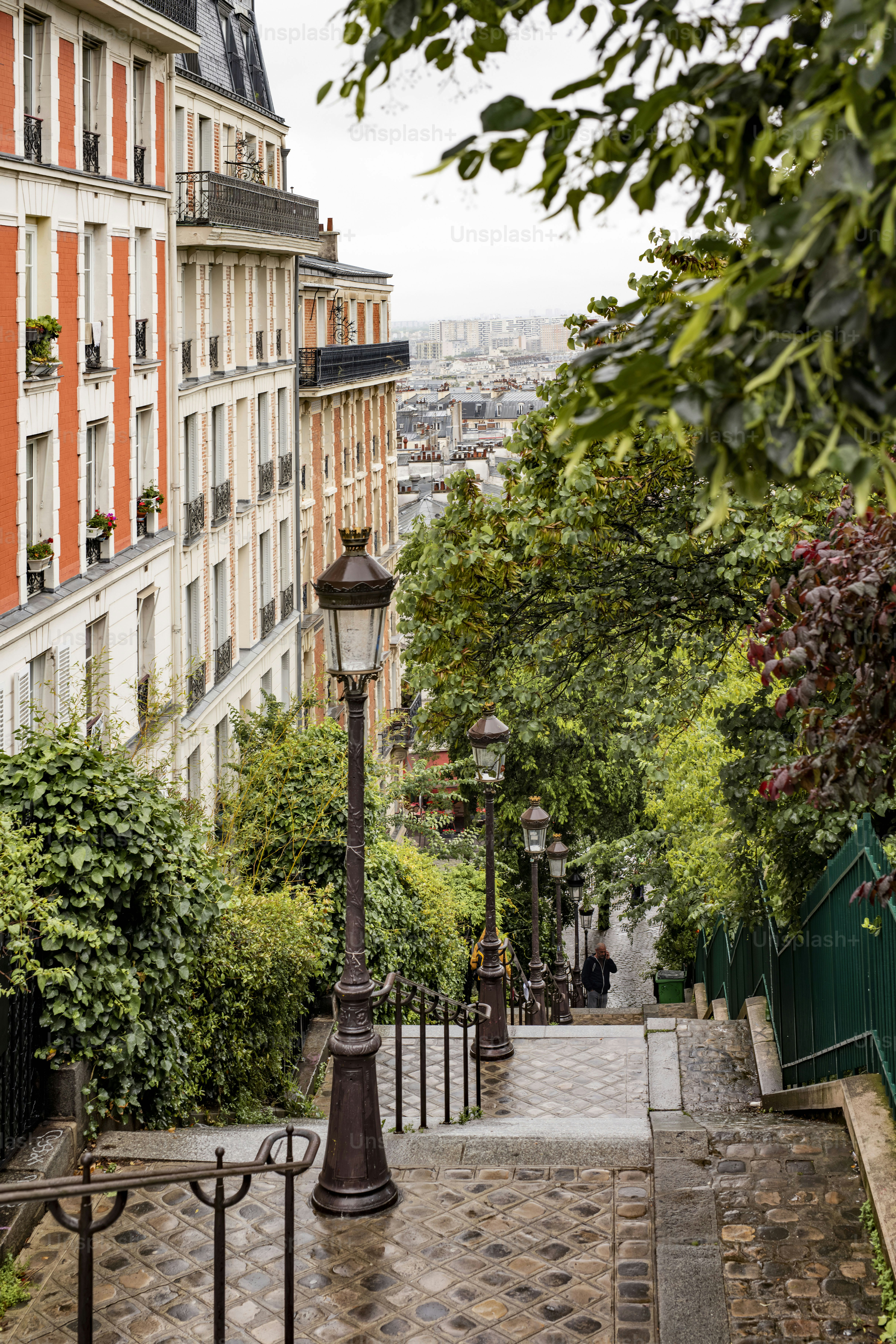 a lamp post on a cobblestone street in a city