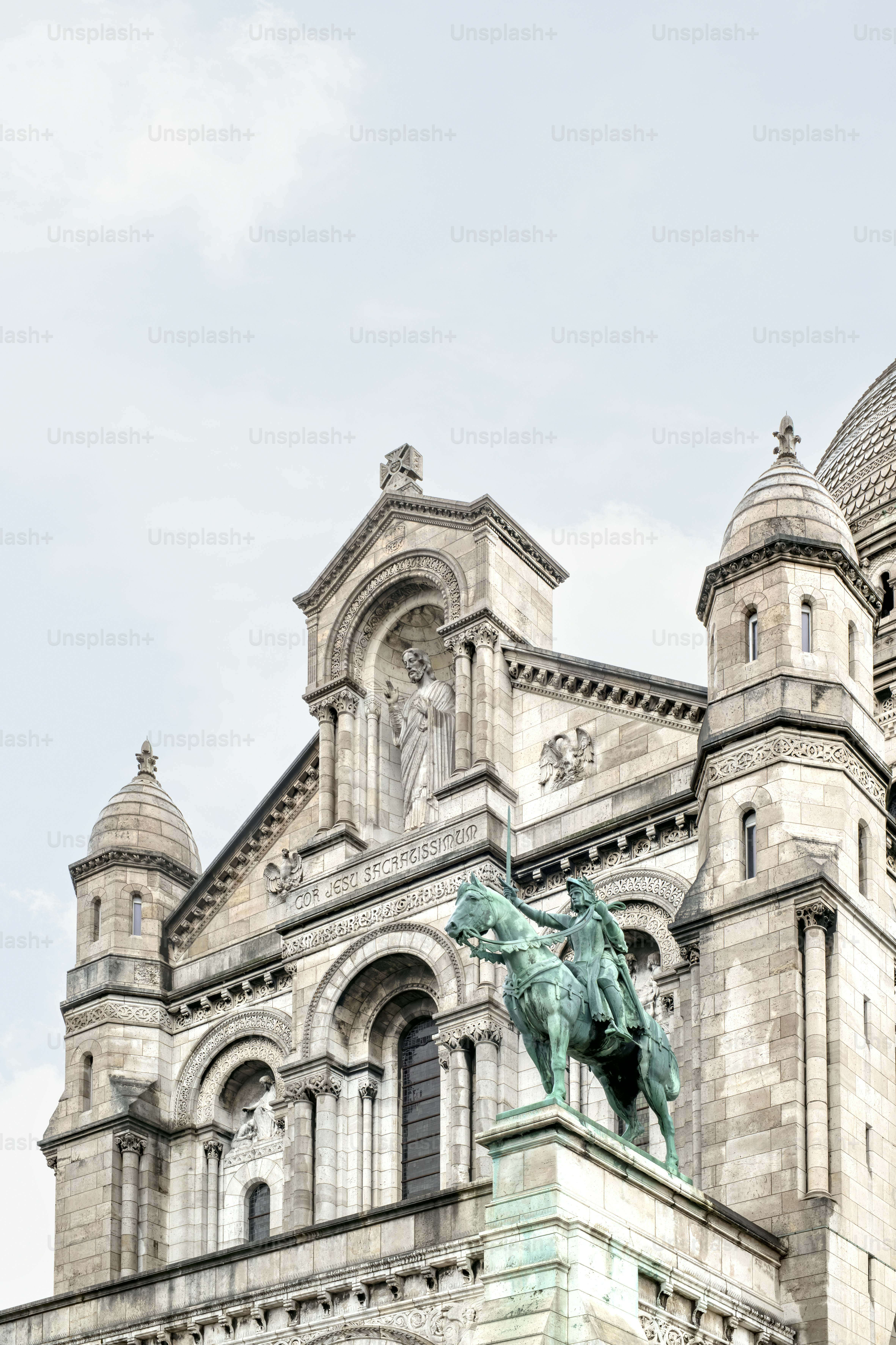 a statue of a man on a horse in front of a building